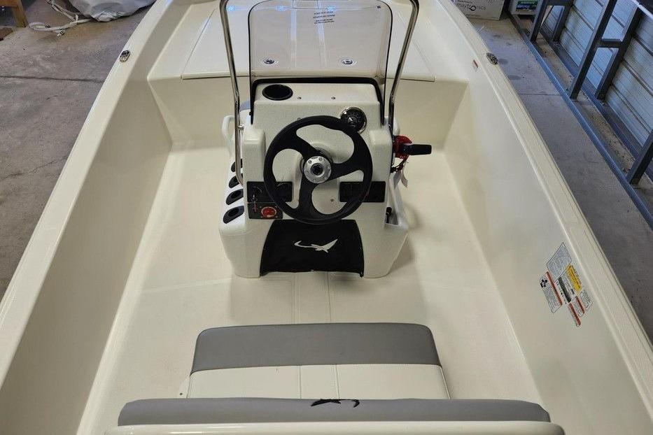 2026 Mako Pro Skiff 17 CC boat interior with steering console and seating.