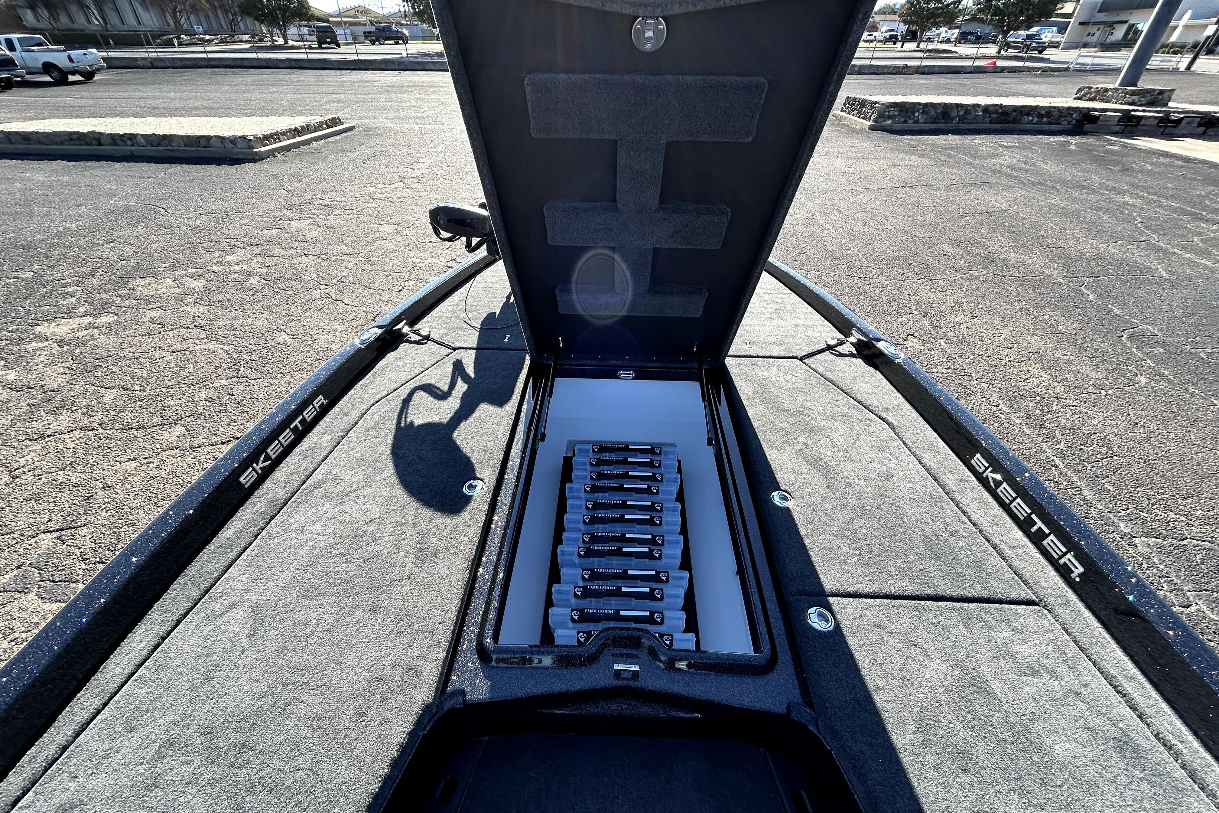 2026 Skeeter ZXE21 boat with open storage compartment, showcasing organized interior layout.