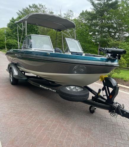 2025 Ranger 1850MS boat on trailer with canopy, parked on brick driveway.