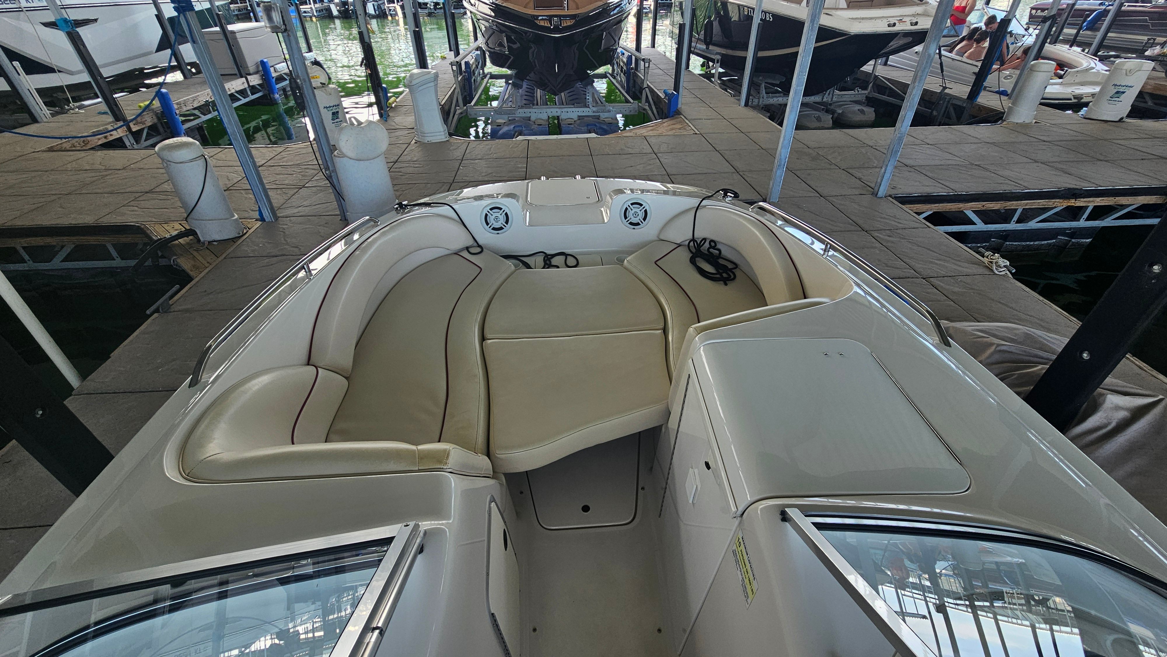 The image shows the cockpit of a 2002 Monterey 220 Explorer Sport with beige upholstery.