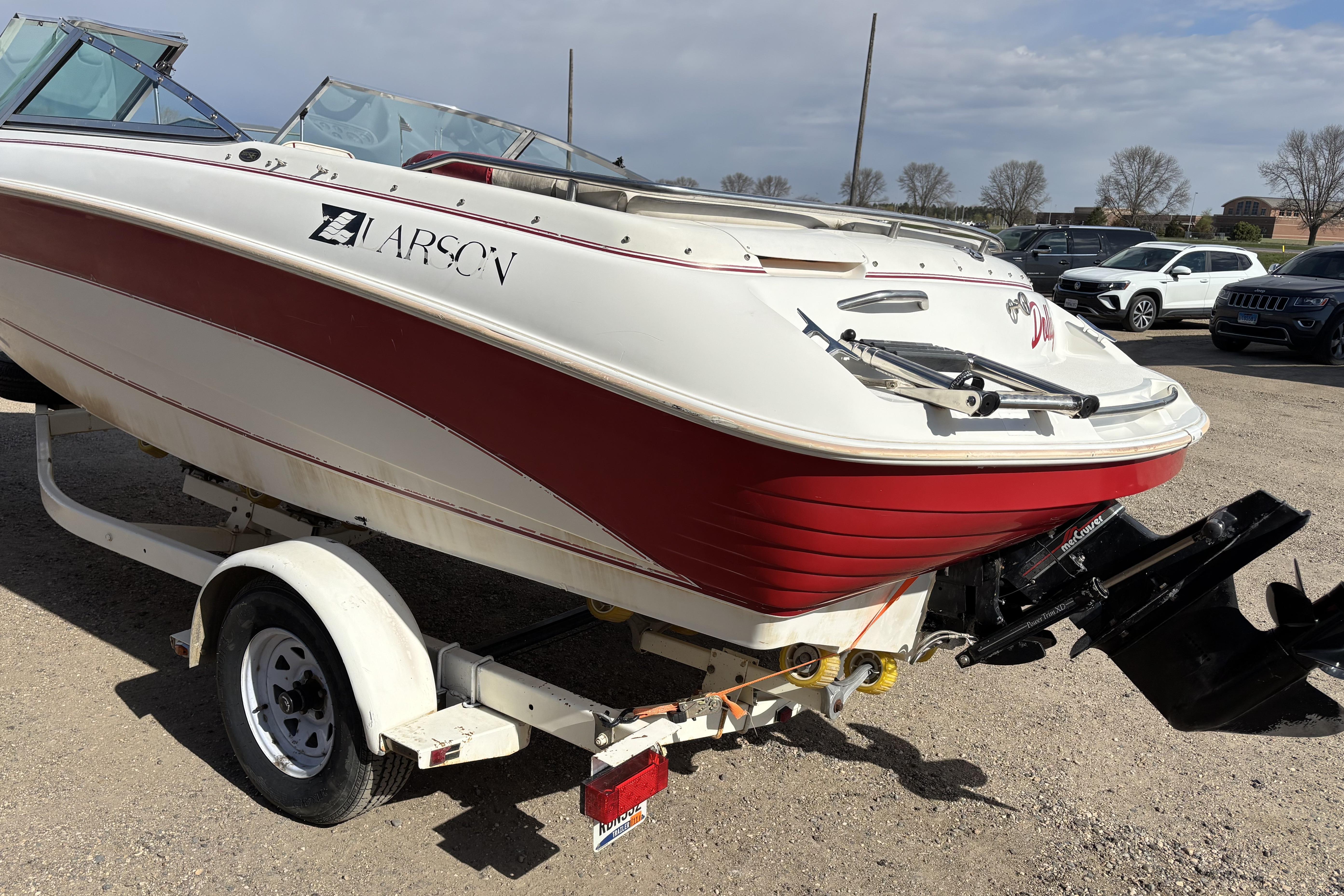 1993 Larson SEi 200 Cuddy I/O boat on trailer, red and white design.