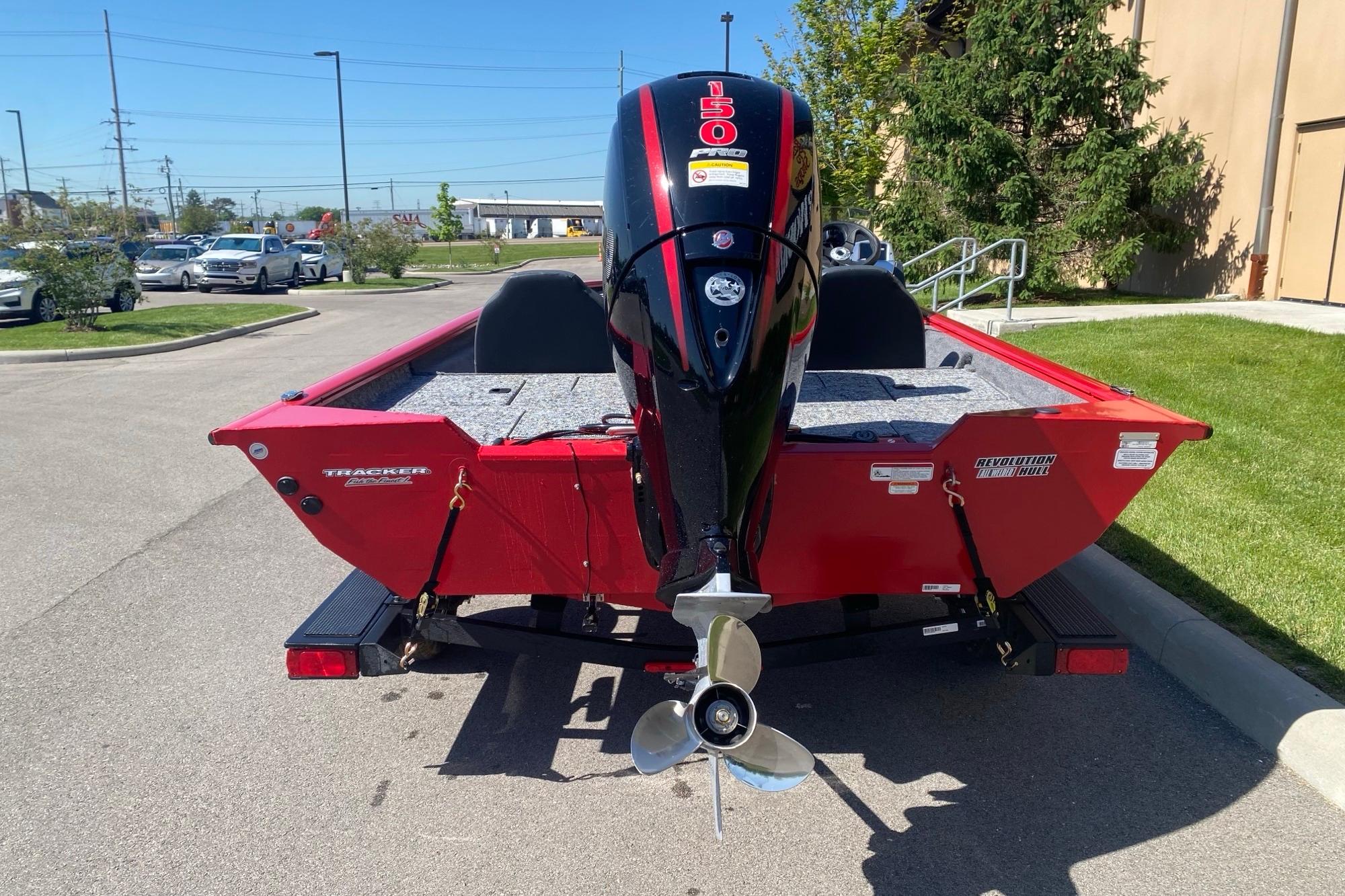2026 Tracker Pro Team 195 boat with powerful outboard motor, parked outdoors.