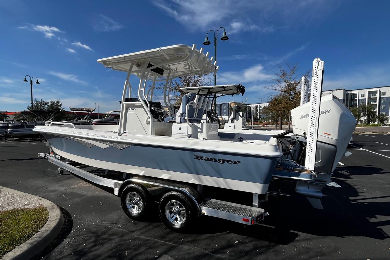 2026 Ranger 2360 Bay boat on trailer, parked outdoors under clear blue sky.