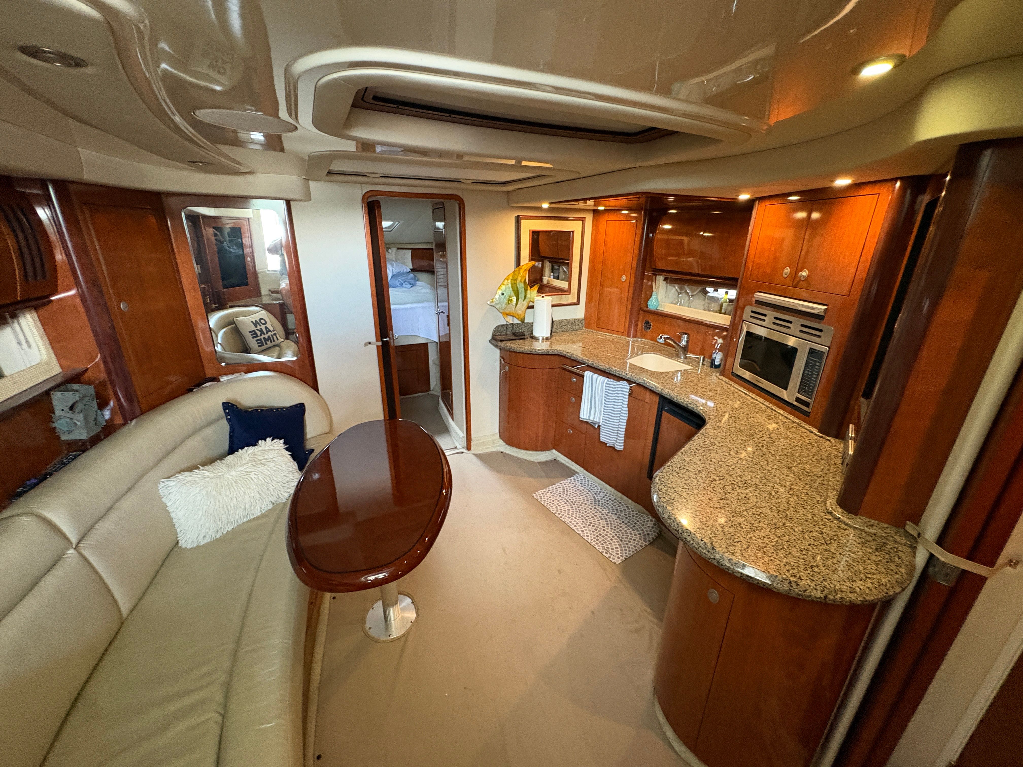Interior of a 2005 Sea Ray 420 Sundancer yacht with kitchen and lounge.
