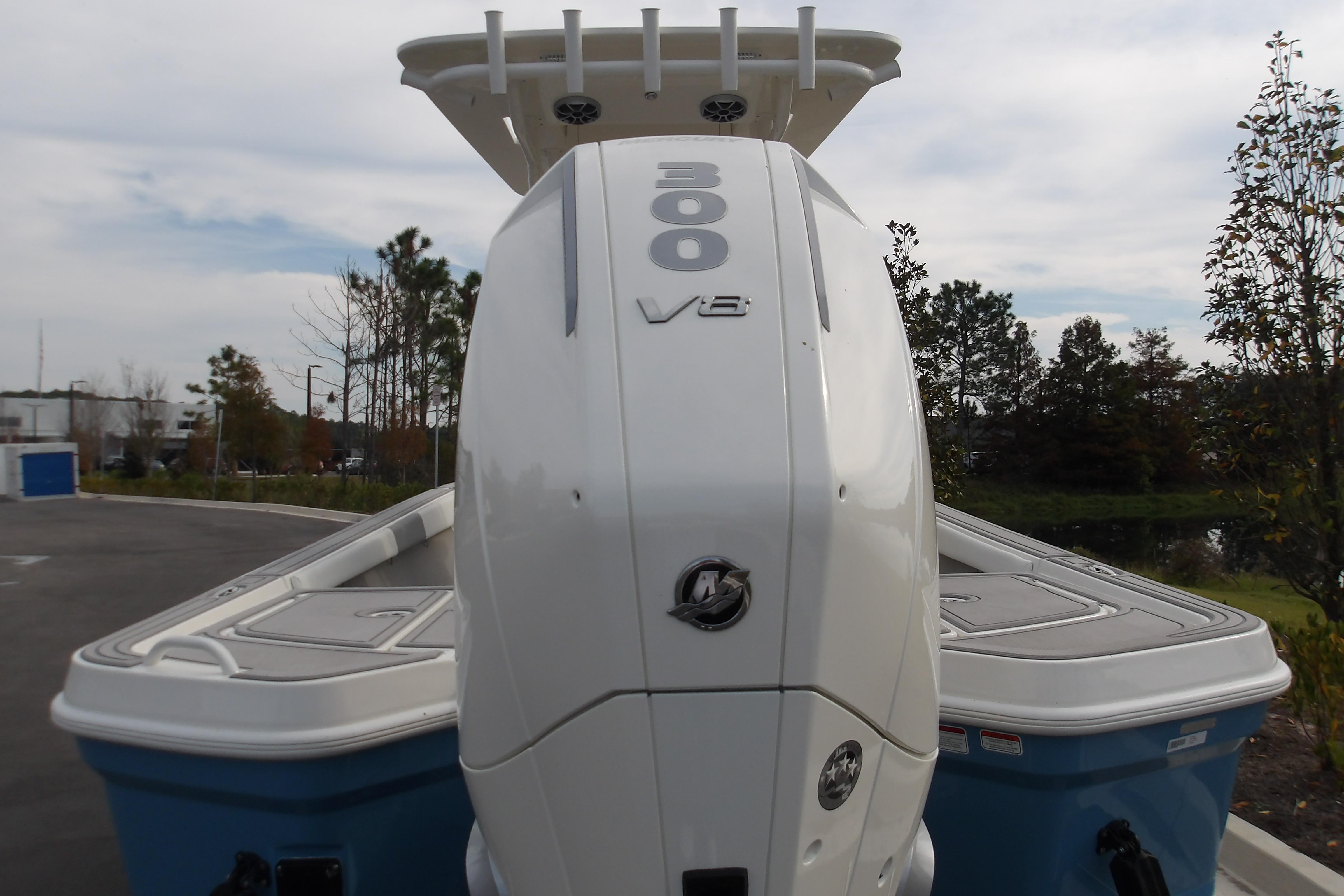 2026 Mako 24 APEX boat with powerful 300 V8 engine, parked outdoors.