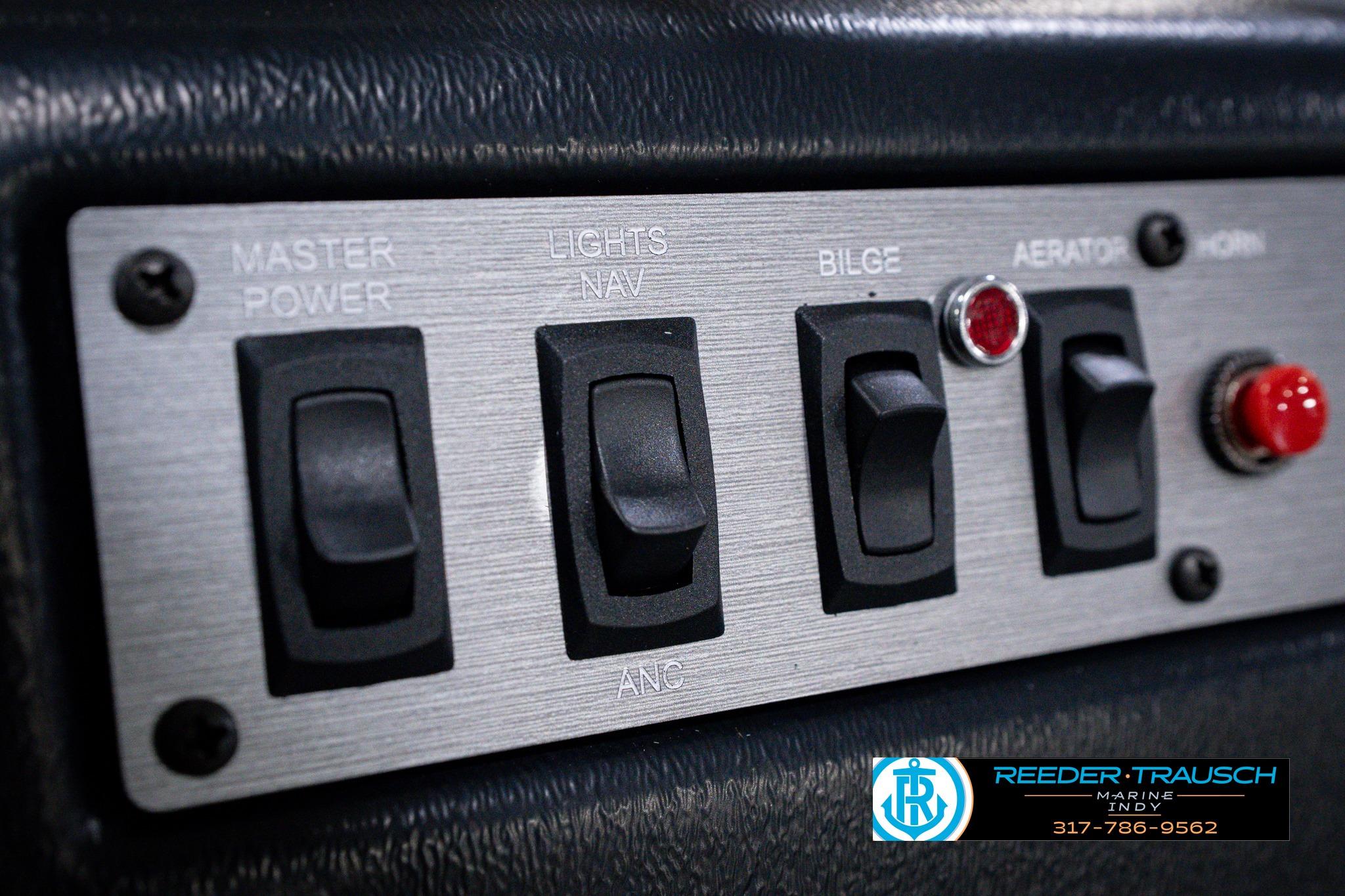 Control panel of 2026 Lund 1600 Fury SS boat with switches for power, lights, and bilge.