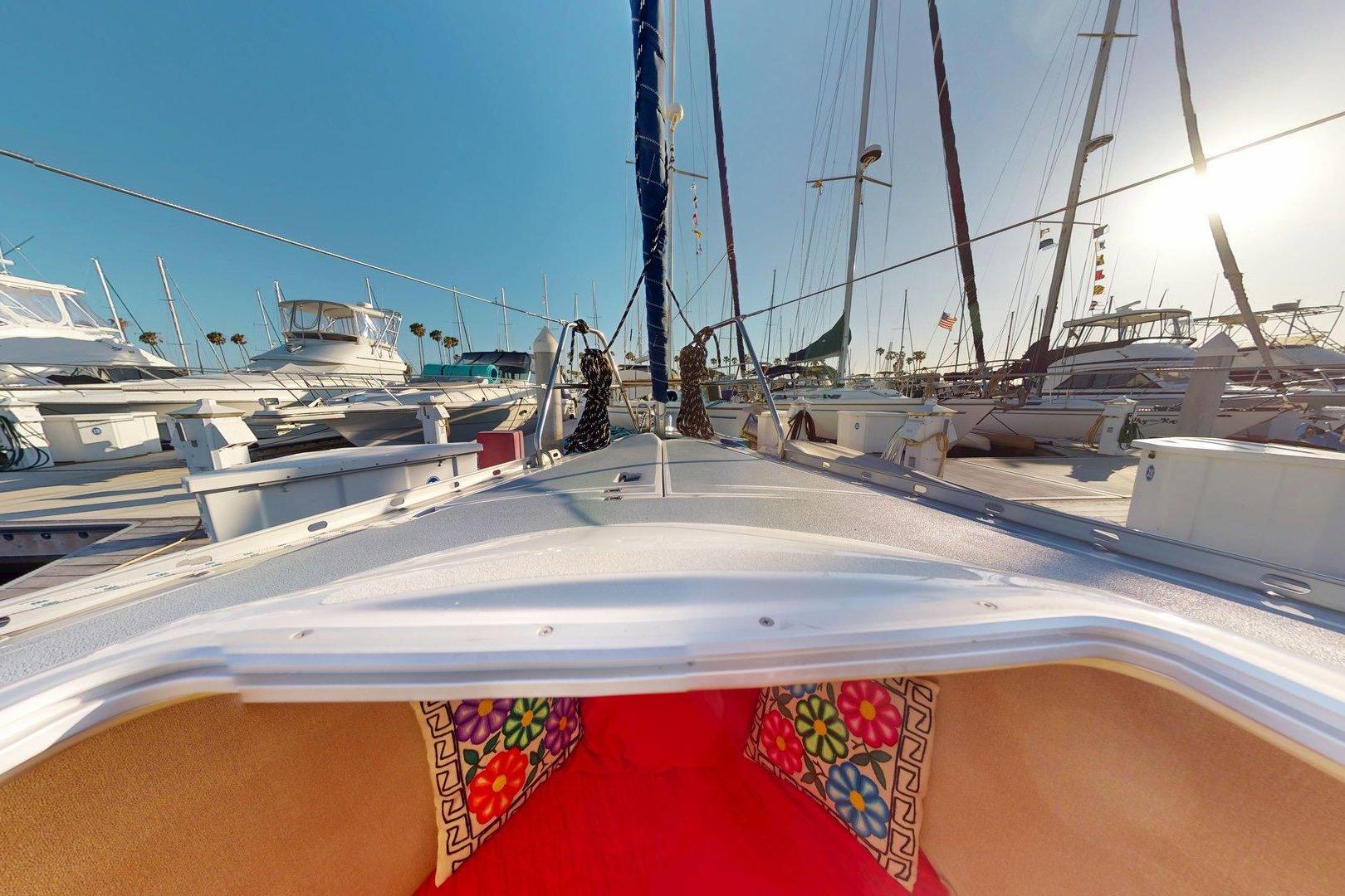 1997 Hunter Legend 40.5 sailboat docked, showcasing vibrant cabin interior and marina view.