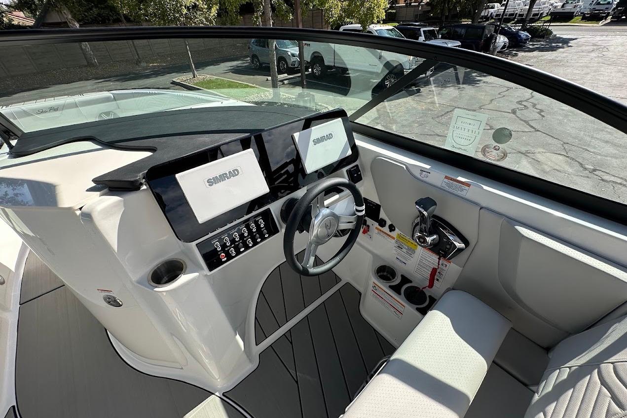 2026 Sea Ray SDX 230 Surf boat cockpit with modern controls and dual Simrad displays.