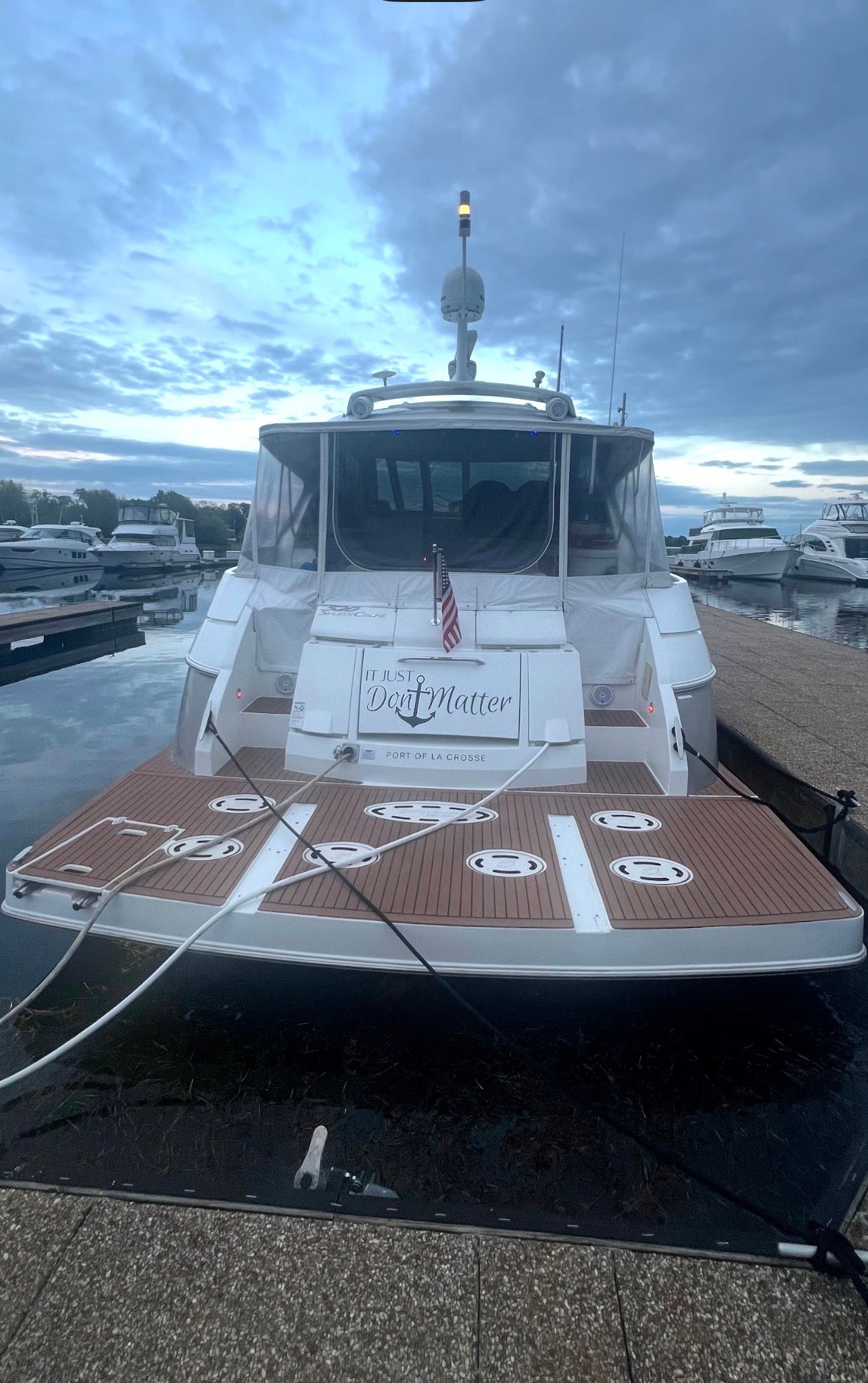 A 2009 Cruisers Yachts 520 Sports Coupe docked. It features a sleek design.