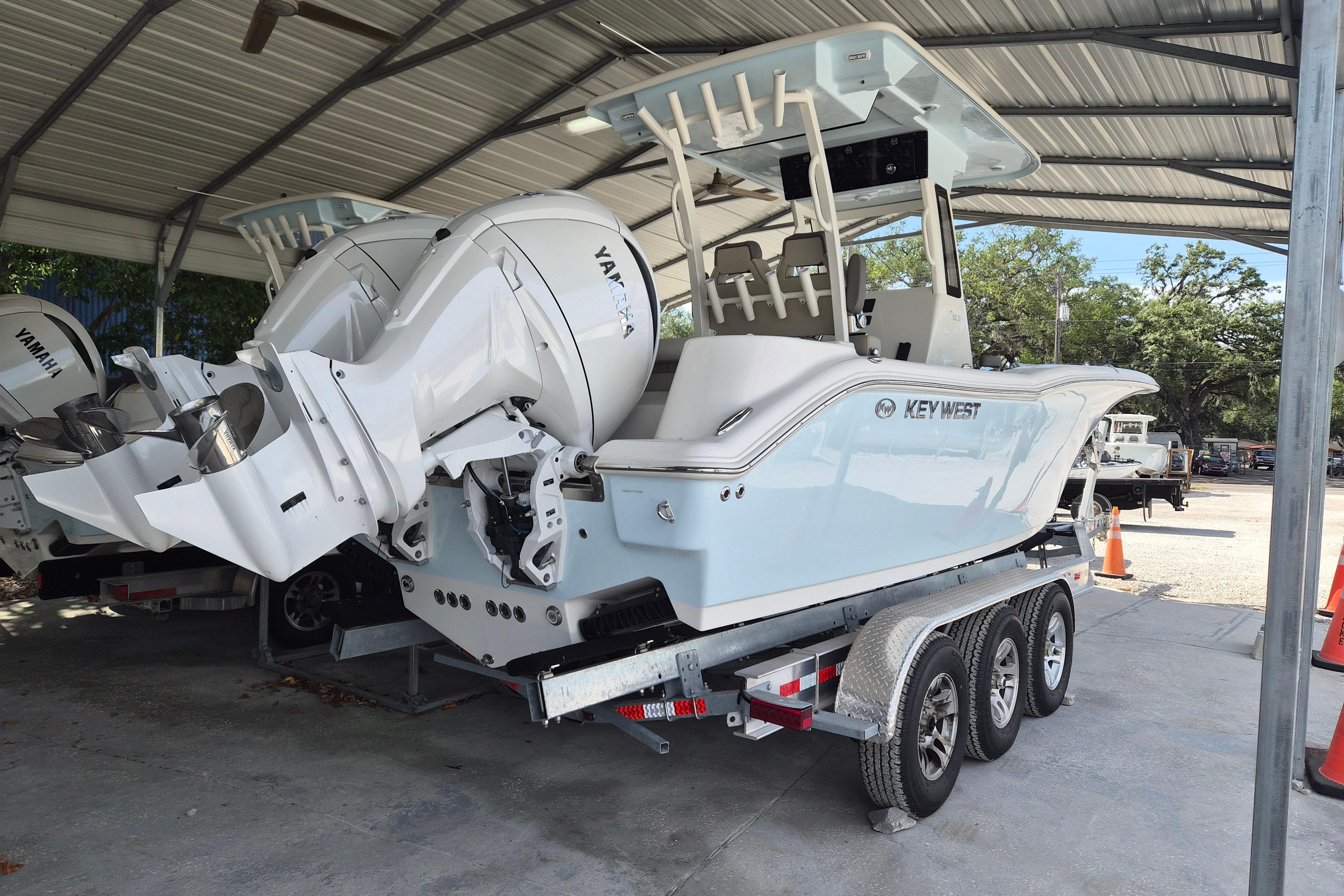 2026 Key West 260 Center Console boat on trailer under shelter.