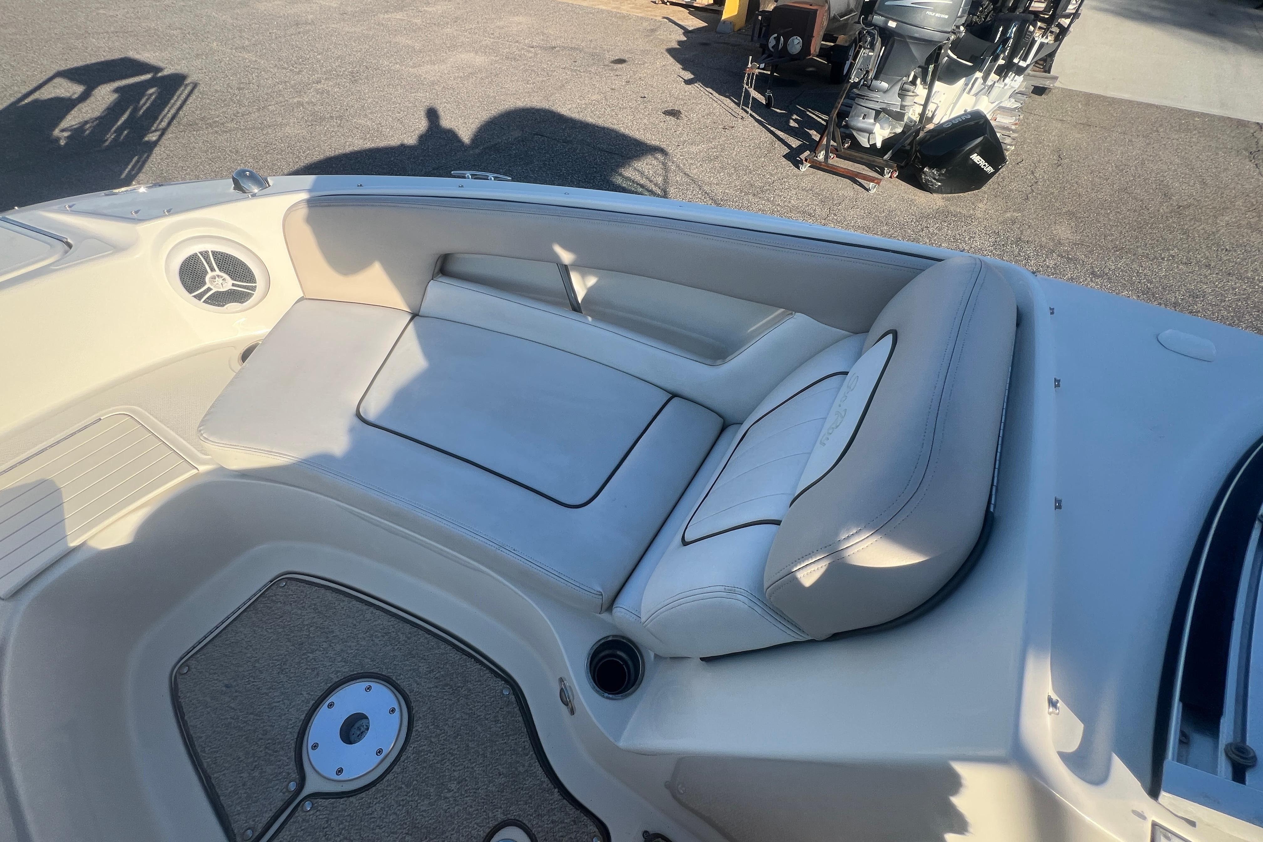 2009 Sea Ray 210 Sundeck interior with cushioned seating and speaker.