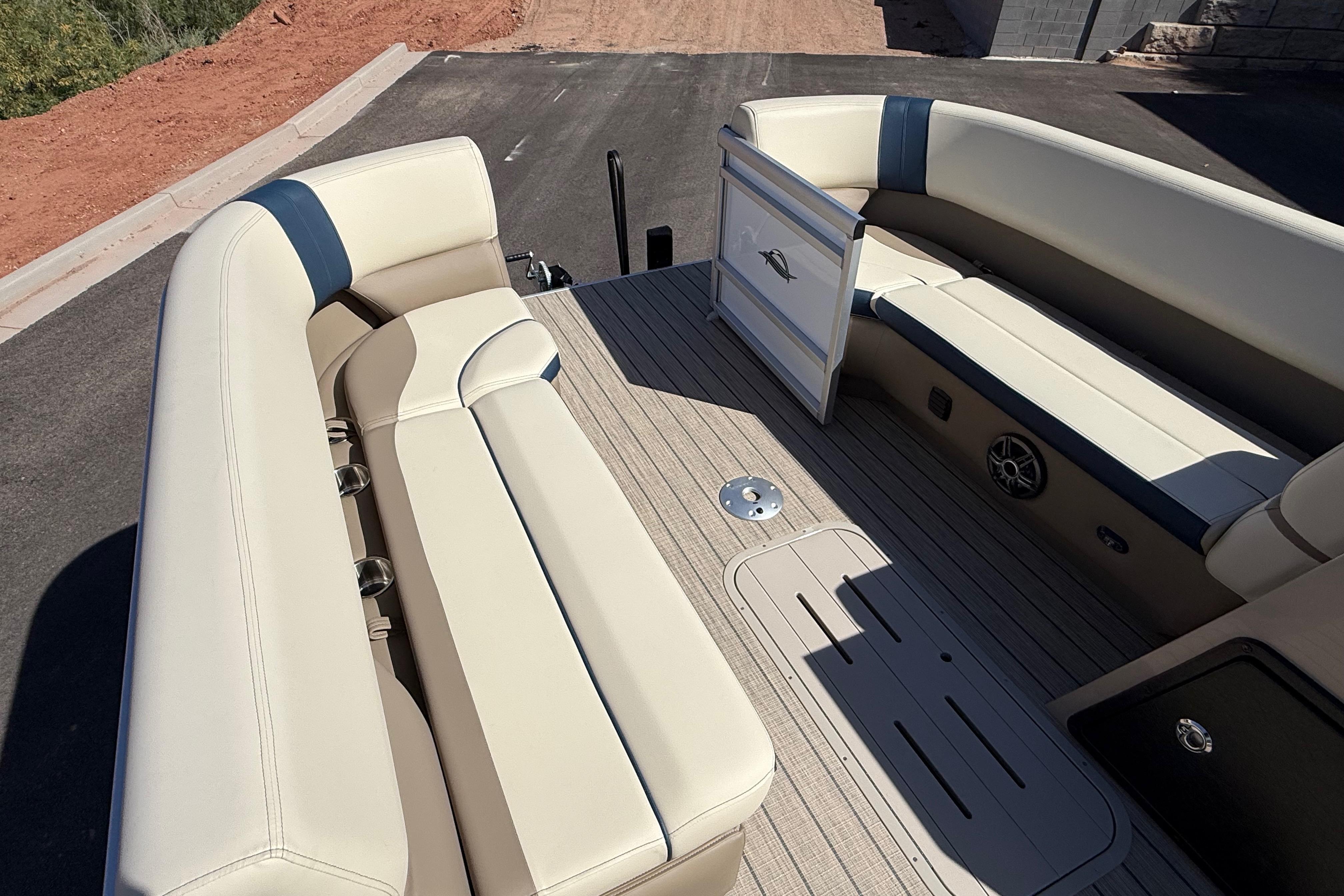 2026 SunCatcher Select 322SL boat interior with beige seating and wood-style flooring.