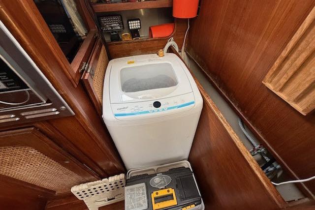 Compact washing machine in the cabin of a 1982 Lancer 45 Motorsailer yacht.