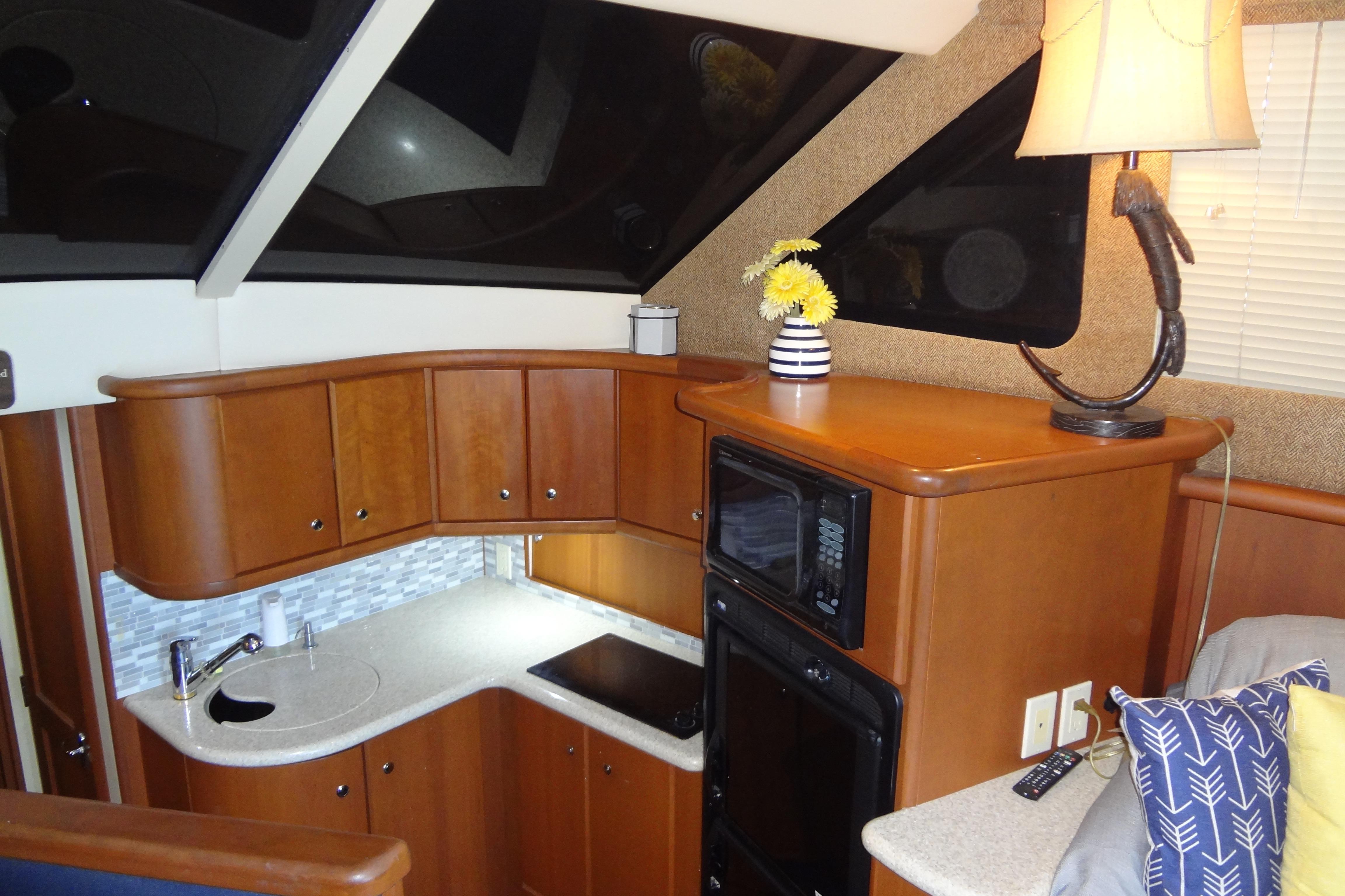 Interior of 2005 Silverton 34 Convertible yacht with modern kitchen and cozy decor.
