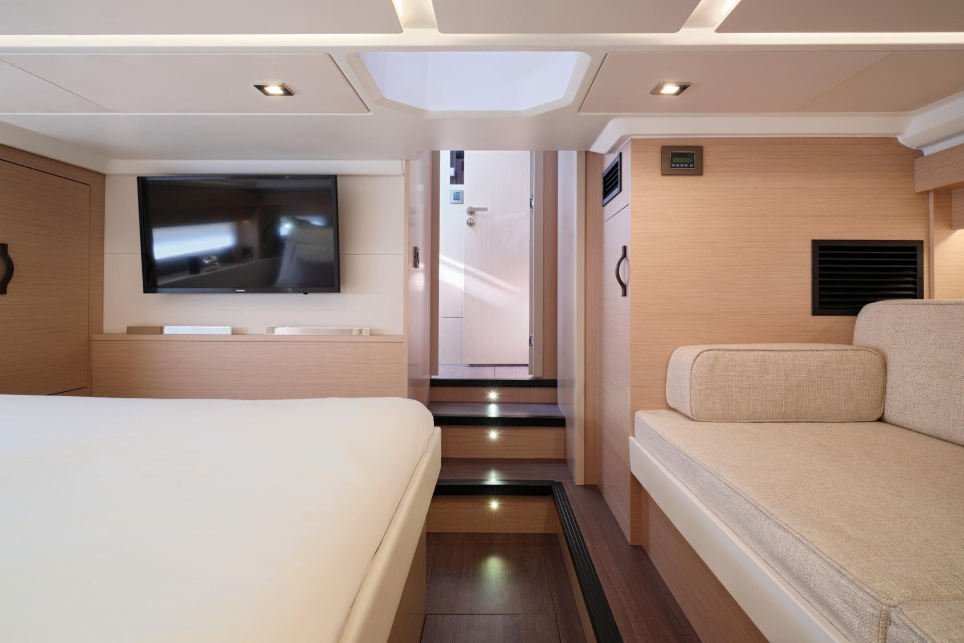 Luxurious interior of 2027 Jeanneau DB/43 OB yacht with modern furnishings and TV.