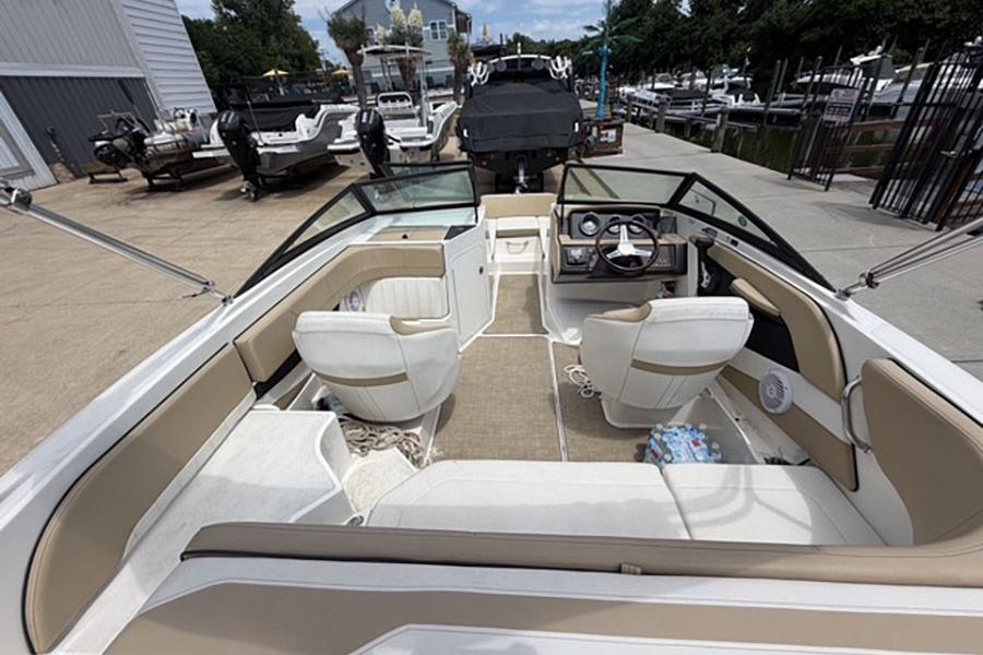 2018 Sea Ray SPX 190 boat interior with beige seating and steering console.