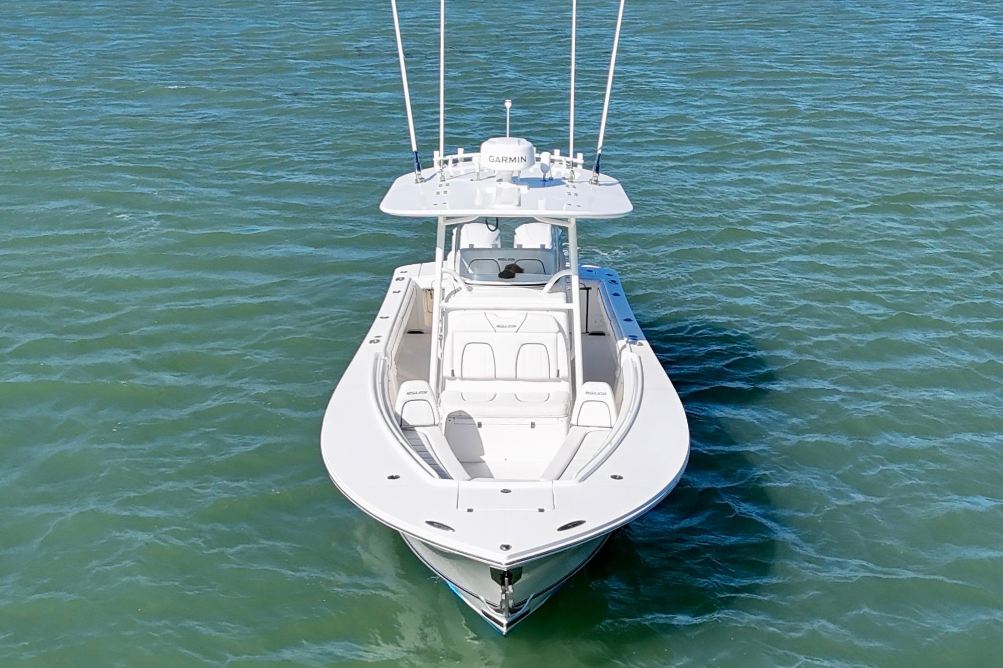 2016 Regulator 28 Forward Seating boat on calm blue water.