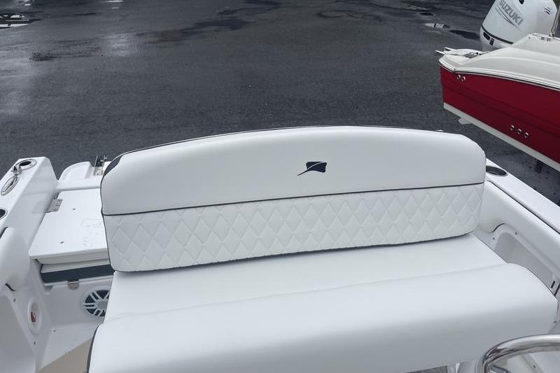 2025 Stingray 173CC boat with white quilted seating, parked on wet pavement.