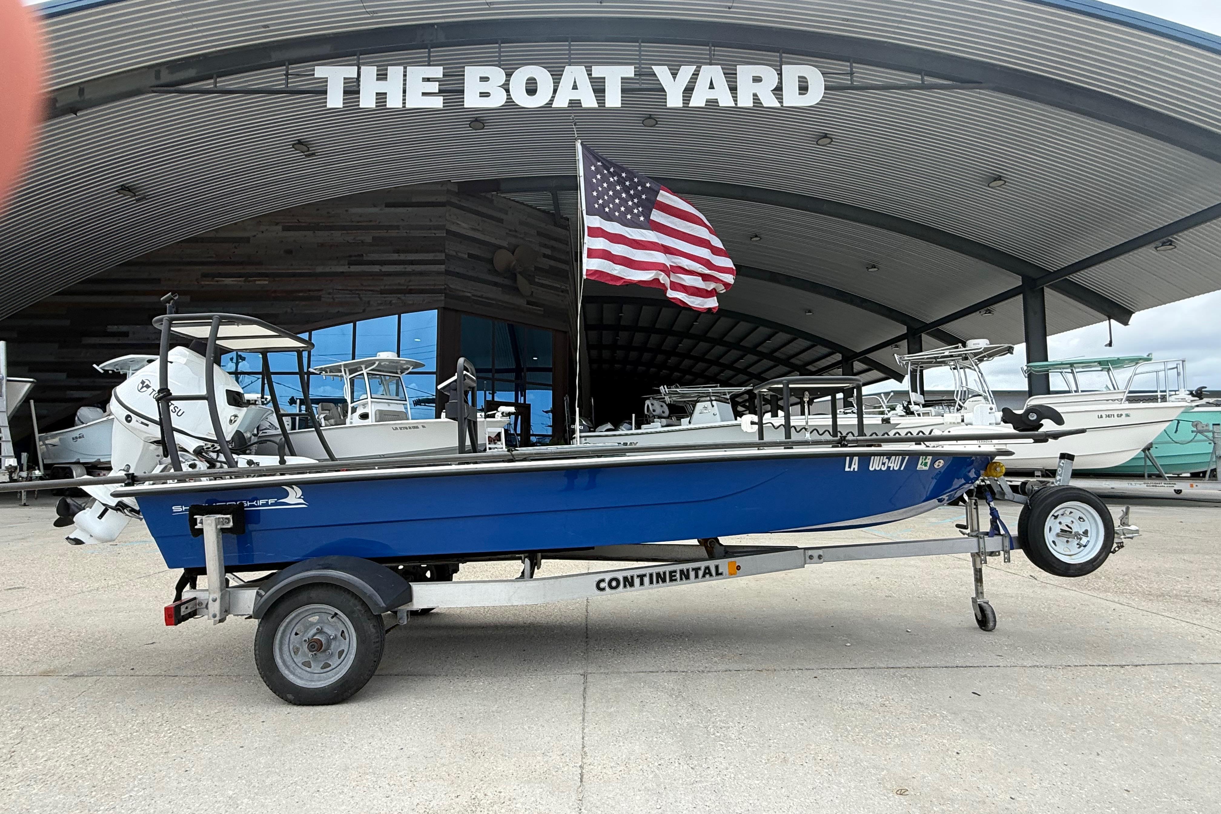 2020 Skimmer Skiff 14 boat on trailer at The Boat Yard with American flag.