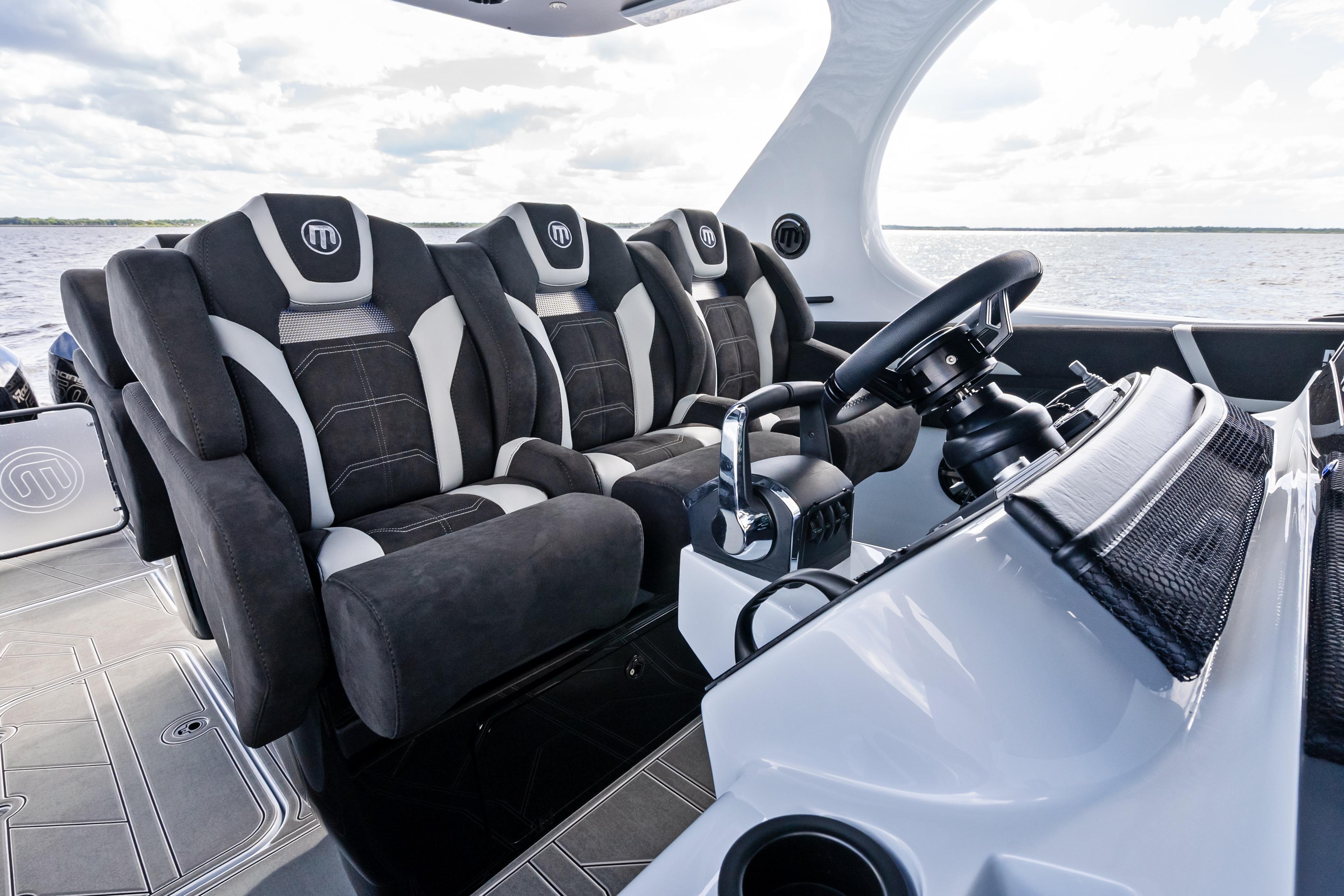 2027 Mystic Powerboats M4200 interior with luxury seating and modern steering console.