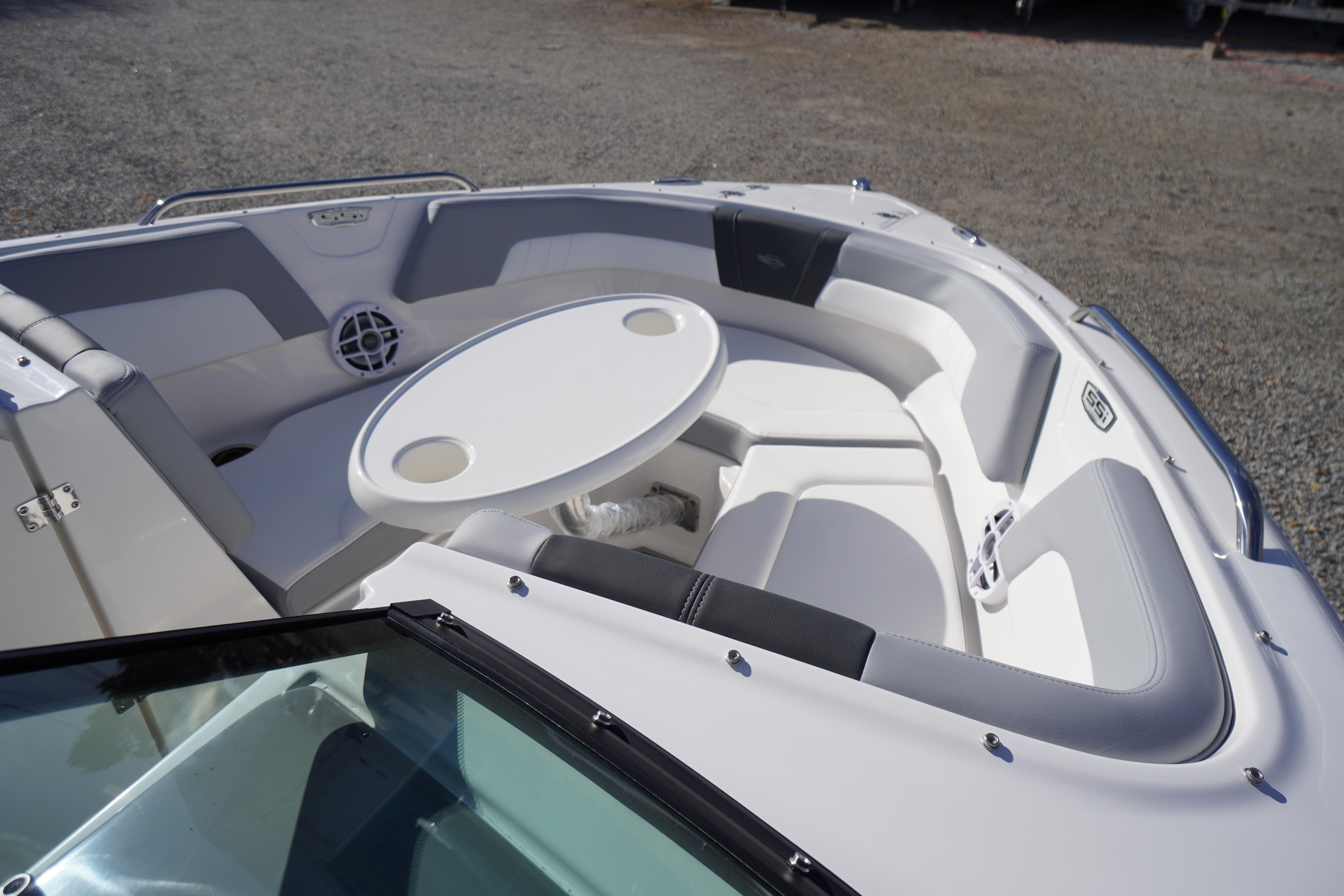 2026 Chaparral 23 SSi OB boat interior with seating and table, showcasing luxury design.