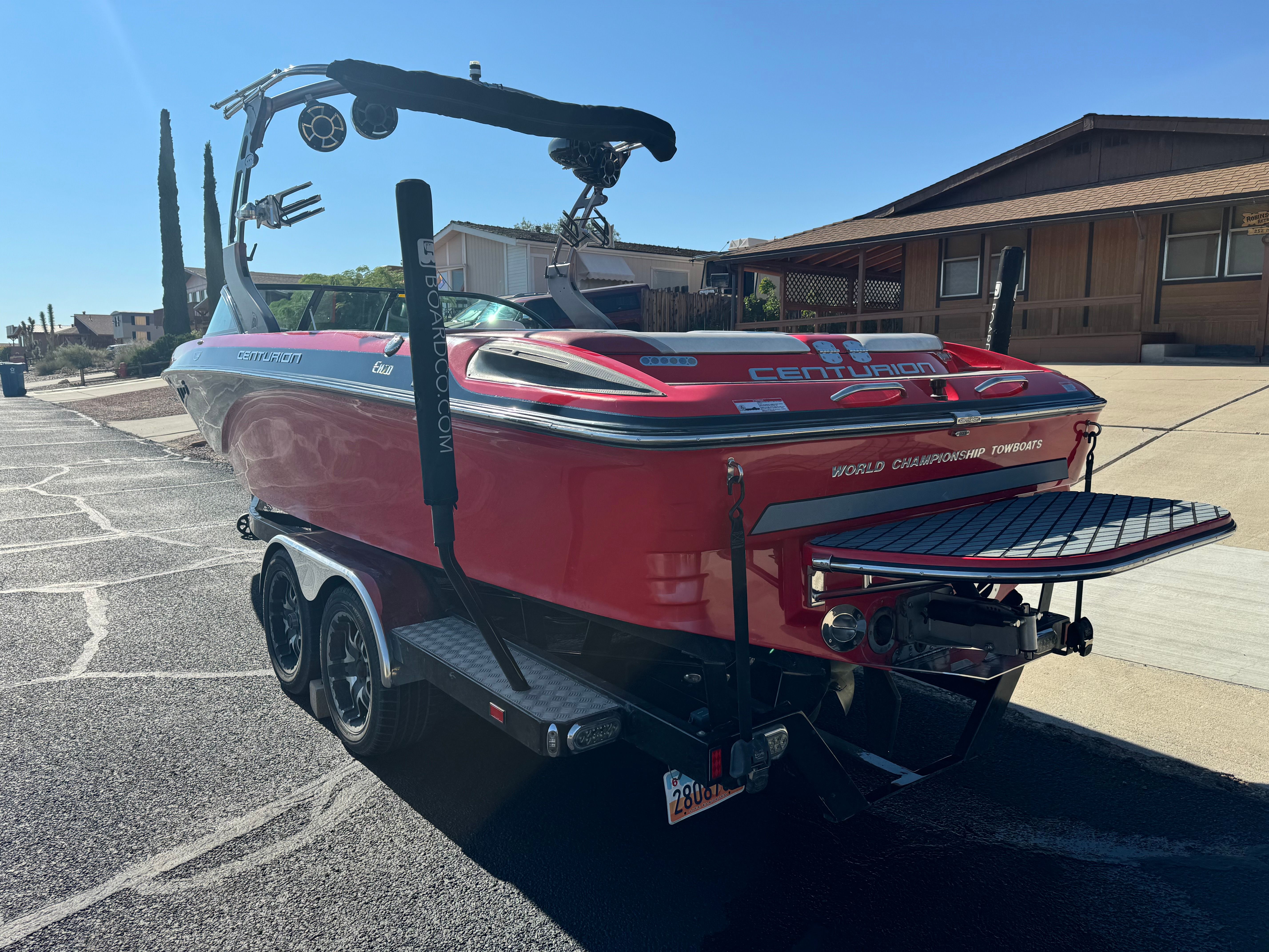 Red 2014 Centurion Enzo FX44 boat parked on trailer.