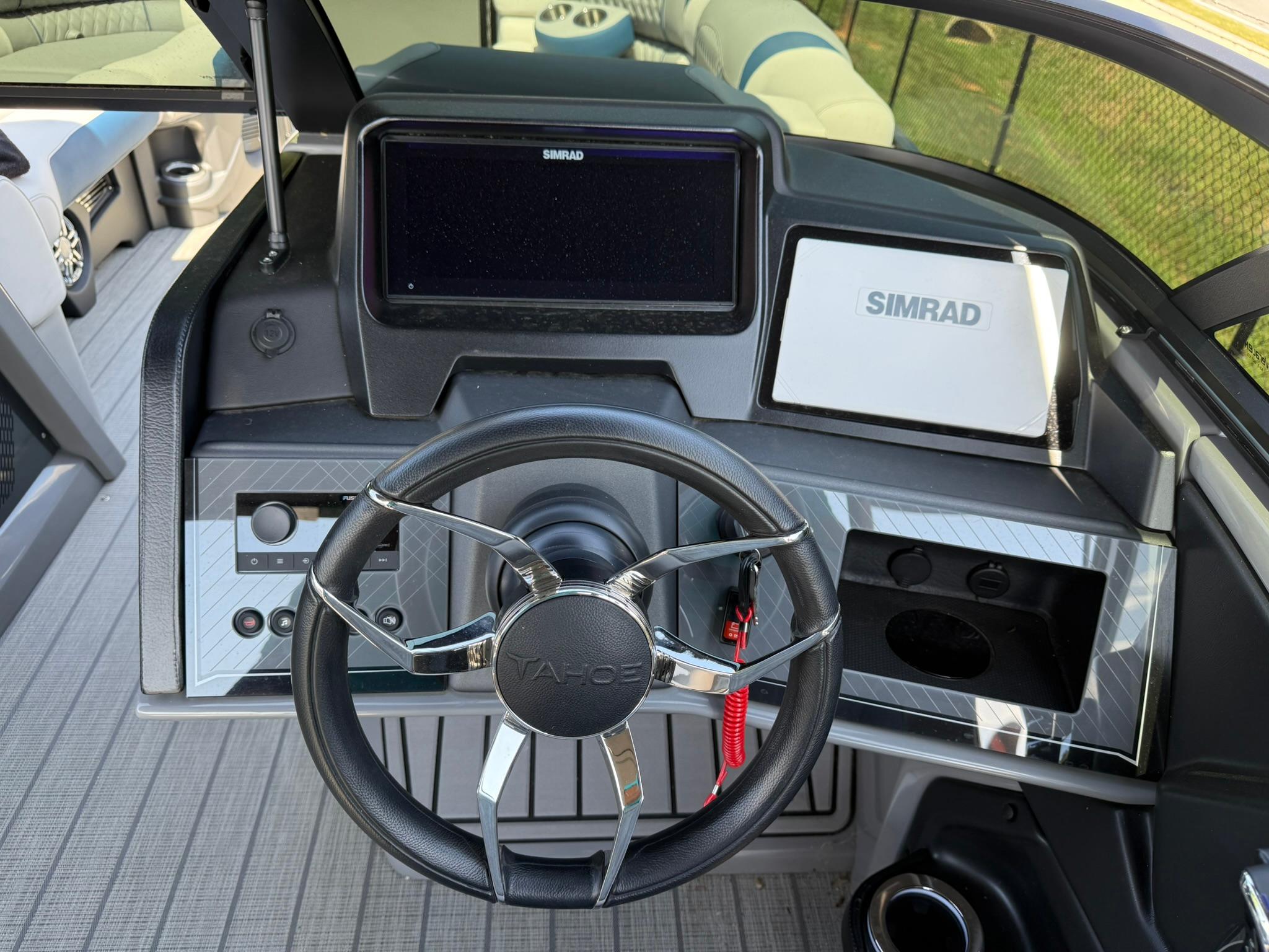 2025 Tahoe Pontoon Grand Tahoe Elite dashboard with steering wheel and Simrad display.