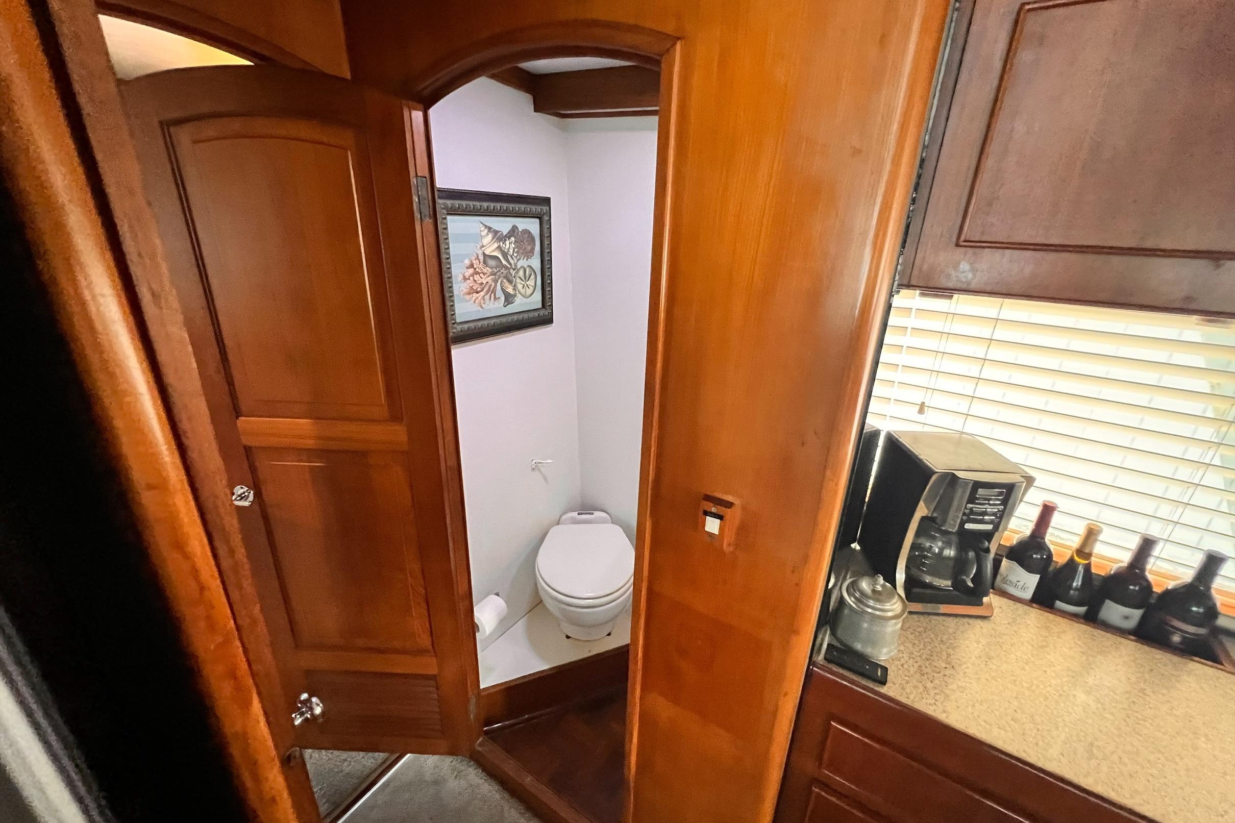 Interior of 1985 Hartman-Palmer yacht with bathroom and kitchen area.
