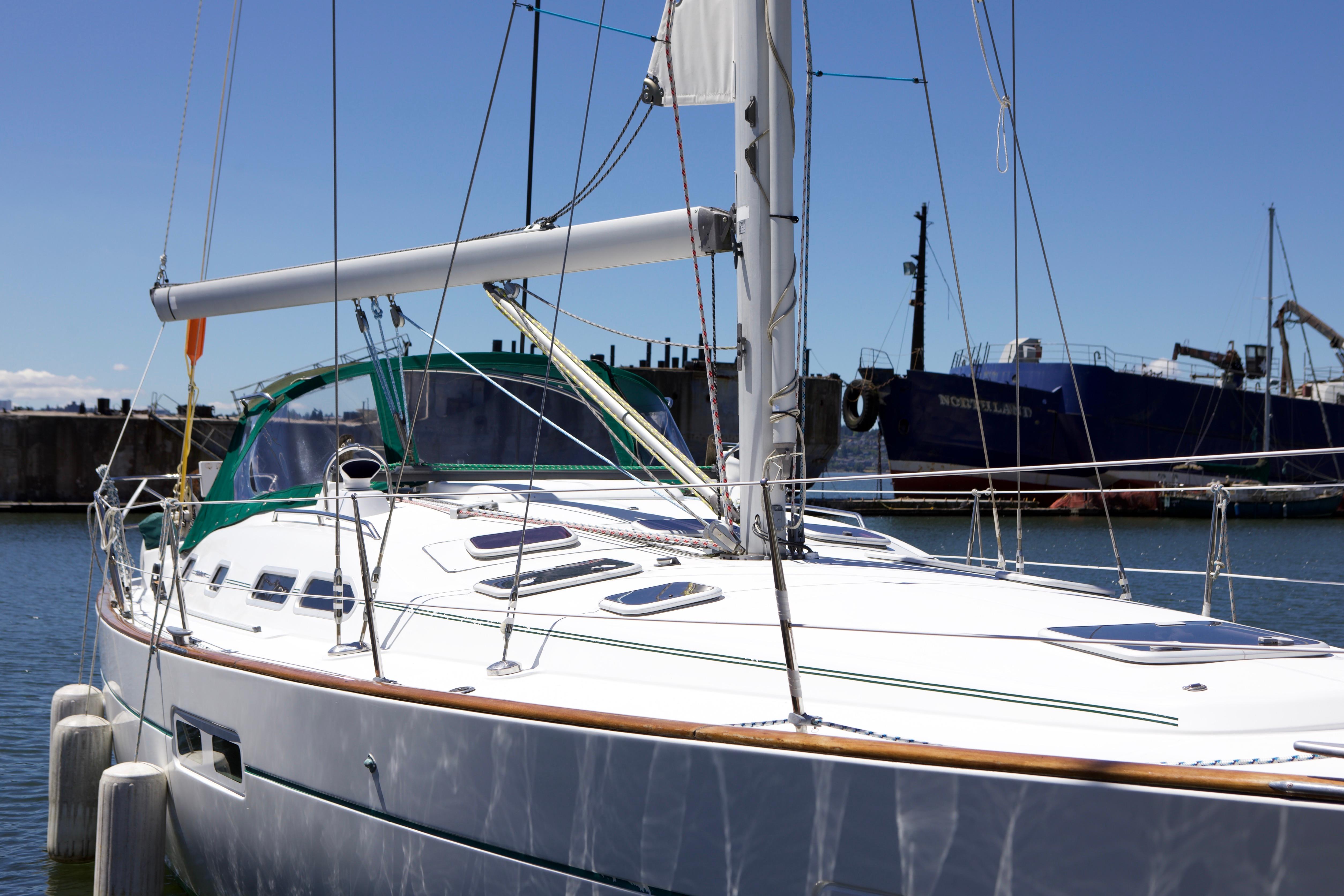 Sailing yacht Beneteau 423, 2005 model, docked in a marina under clear skies.