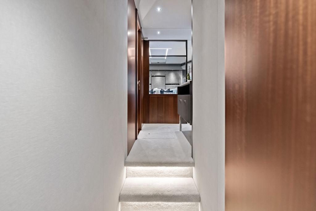 Interior hallway of 2026 Sunseeker 88 Yacht with modern design and wooden accents.