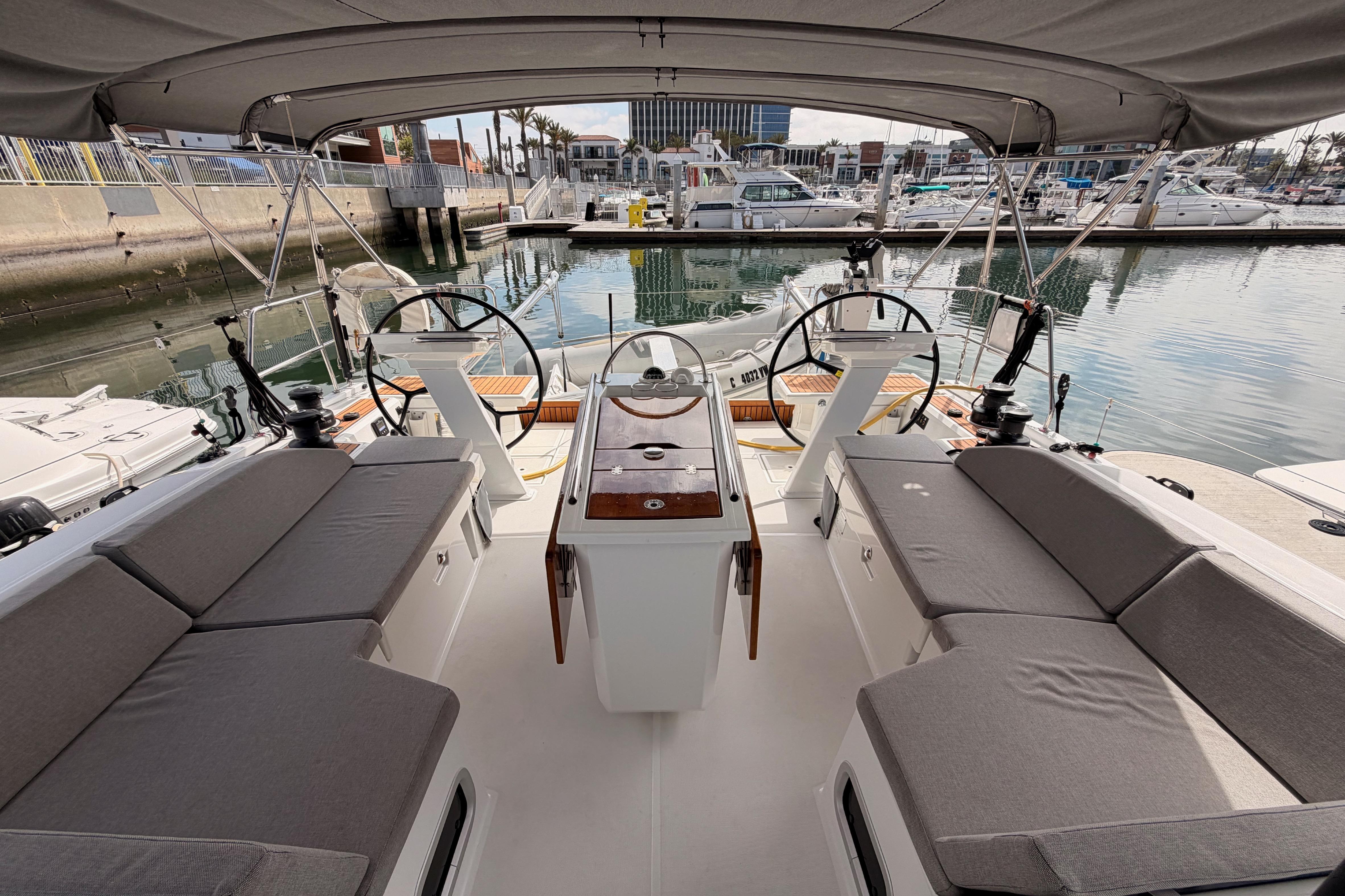 Spacious cockpit of 2020 Beneteau Oceanis 46.1 yacht docked at marina.