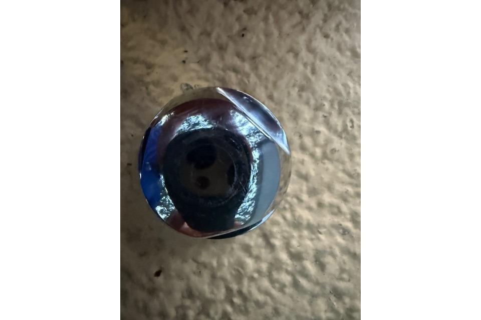 Close-up of a shiny metal knob on a 2016 Boston Whaler 150 Montauk boat.