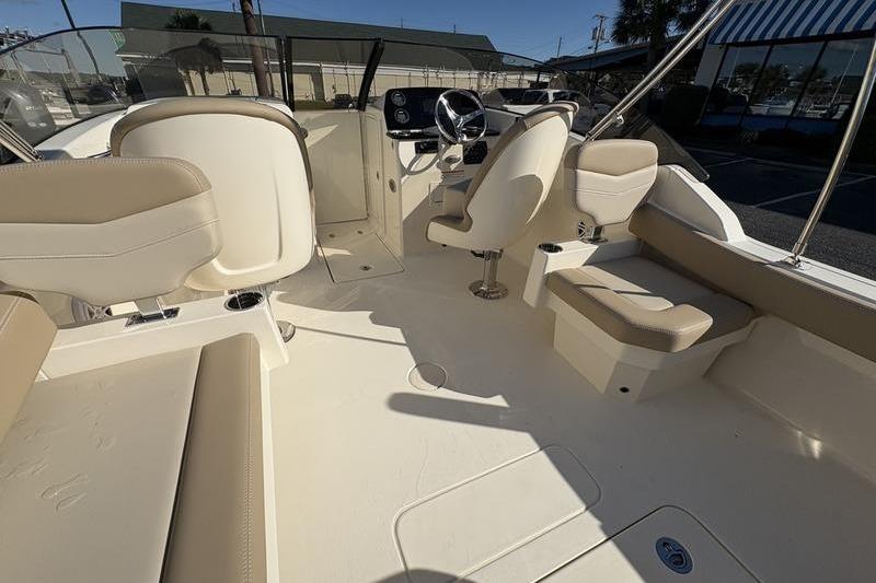 2026 Scout 222 Dorado boat interior with beige seating and steering console.