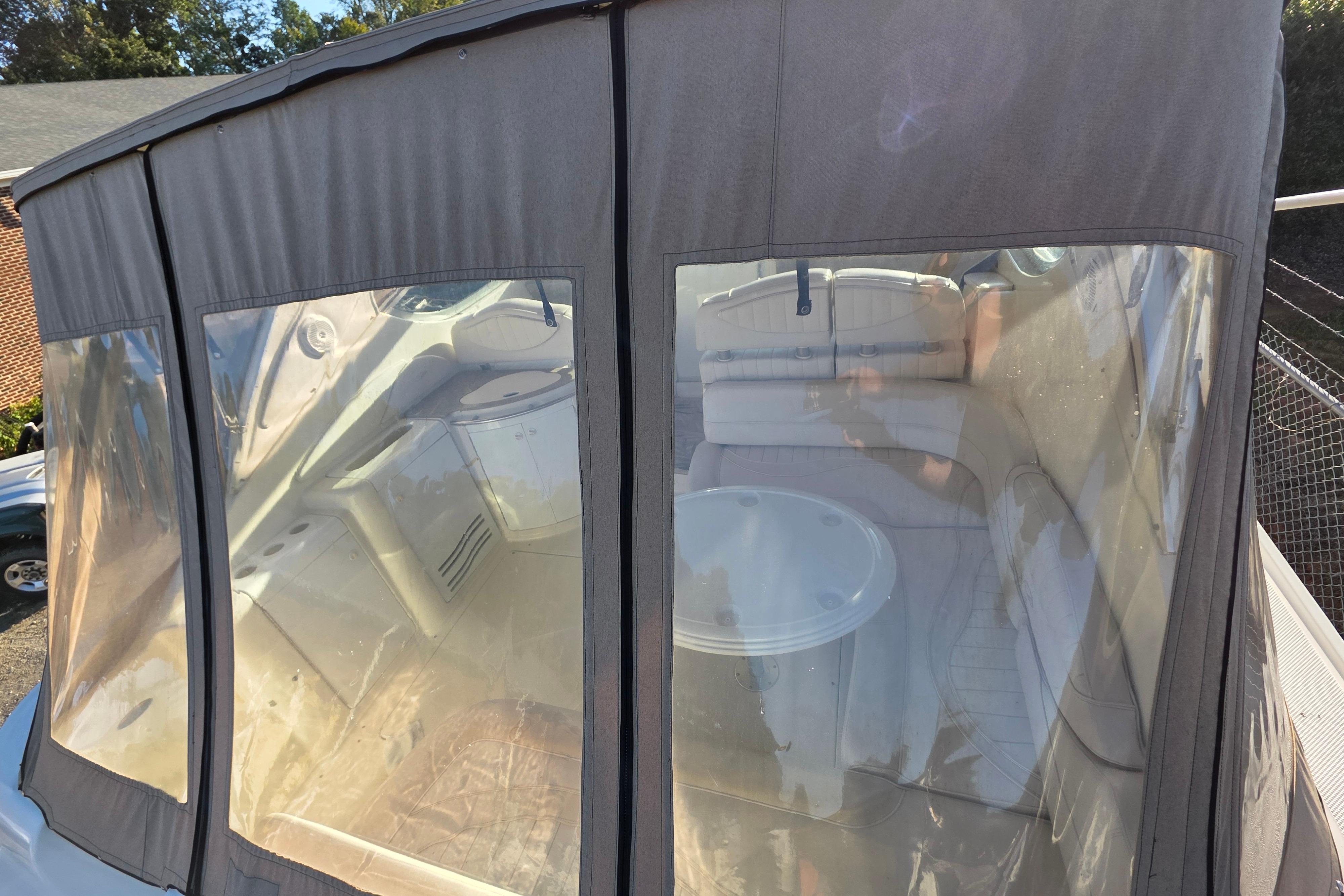 1998 Maxum 3700 SCR boat interior with protective cover and visible seating area.