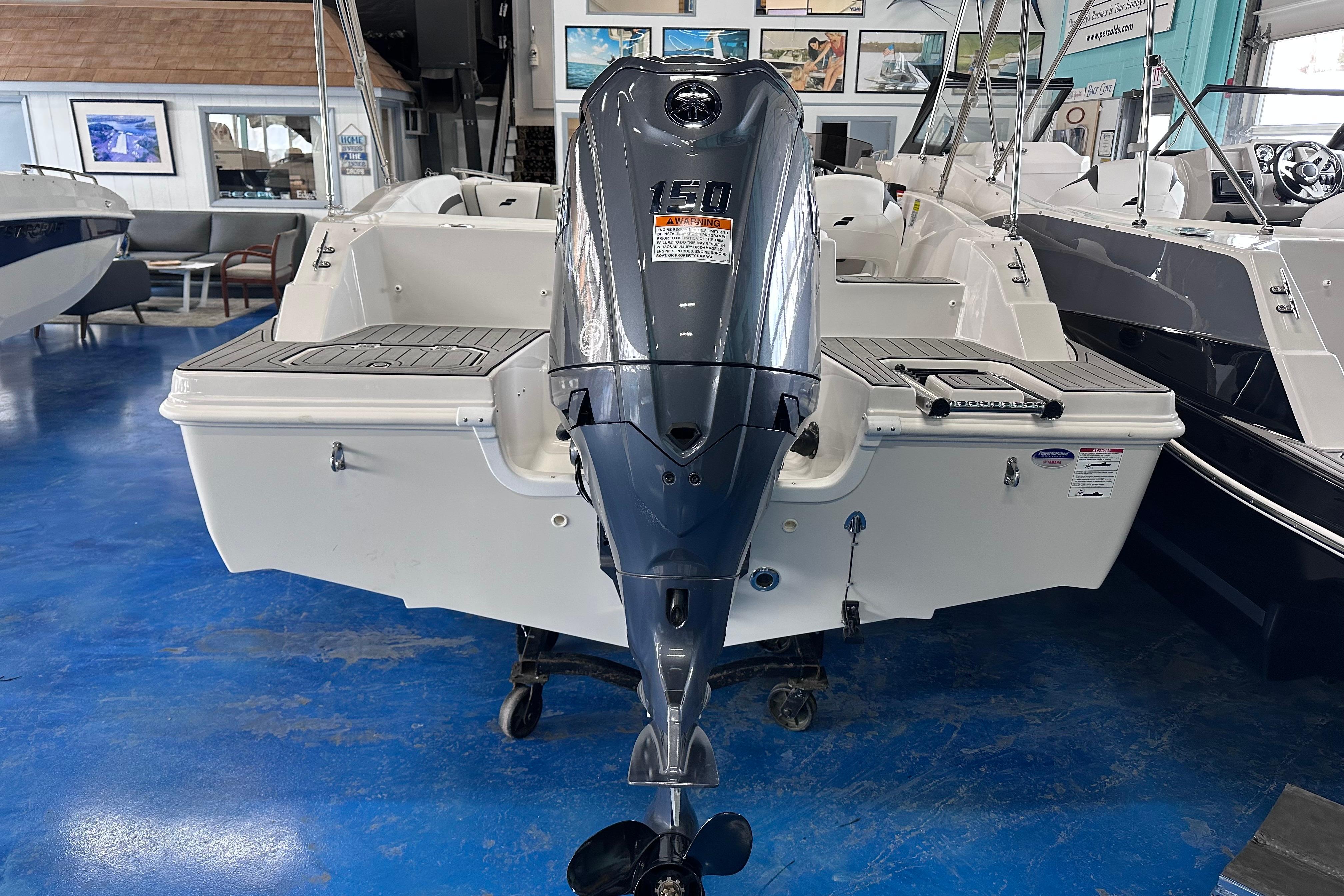 2026 Starcraft SVX 191 OB boat with 150 HP outboard motor in showroom.