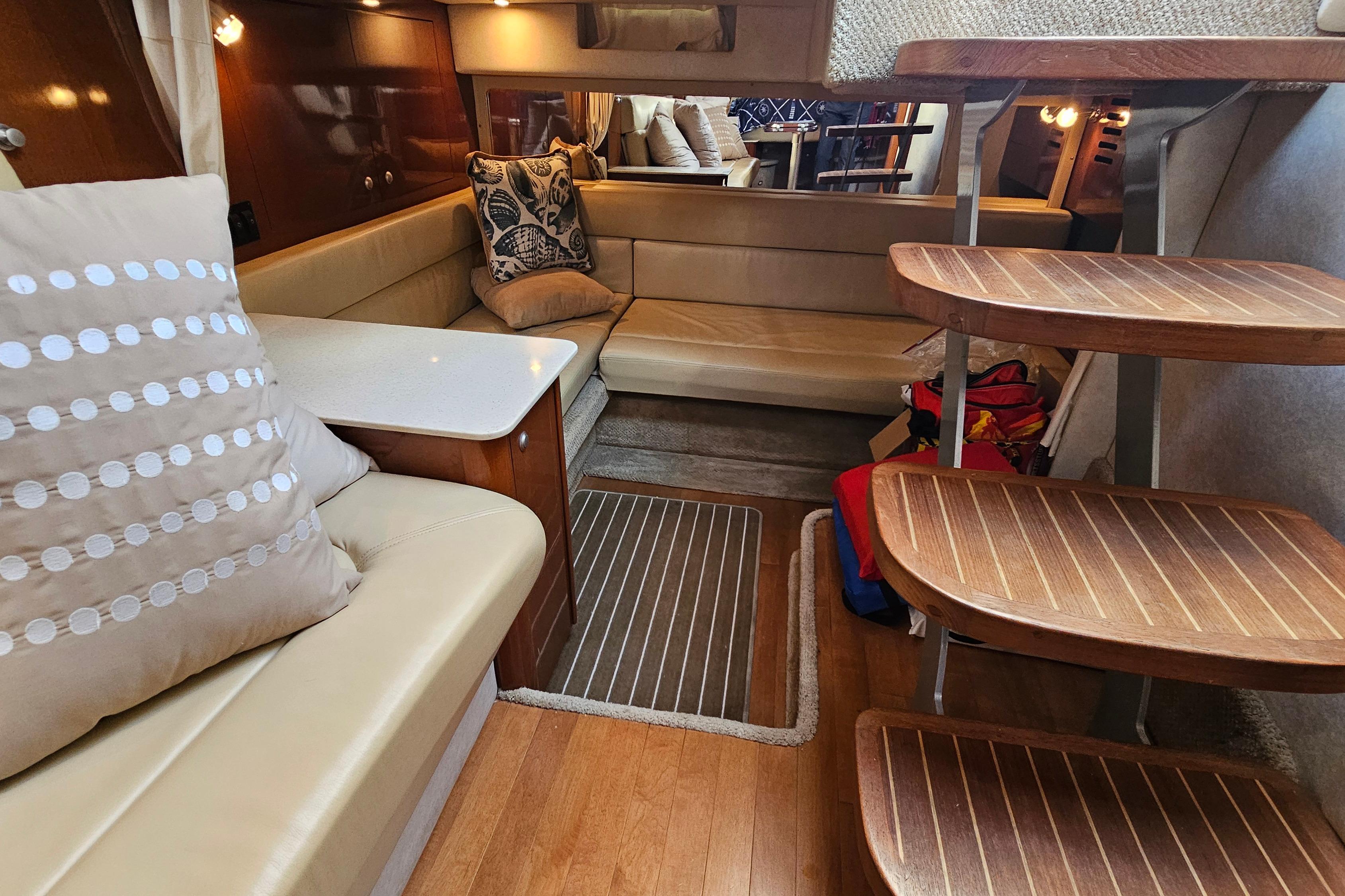 Luxurious interior of 2008 Sea Ray Sundancer 350 yacht with plush seating and wooden steps.