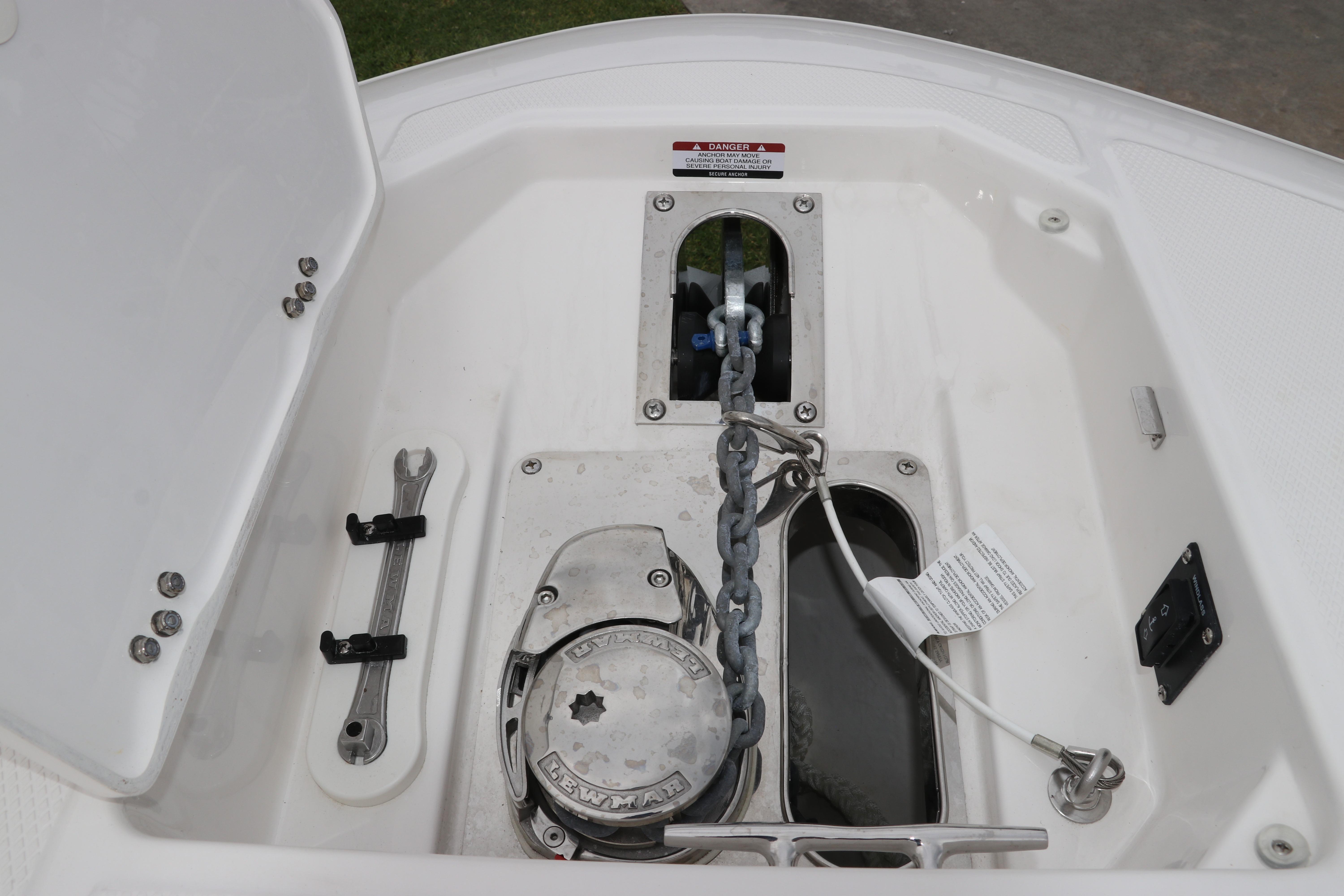 Anchor compartment of 2026 Robalo R257 Dual Console boat, featuring chain and winch.