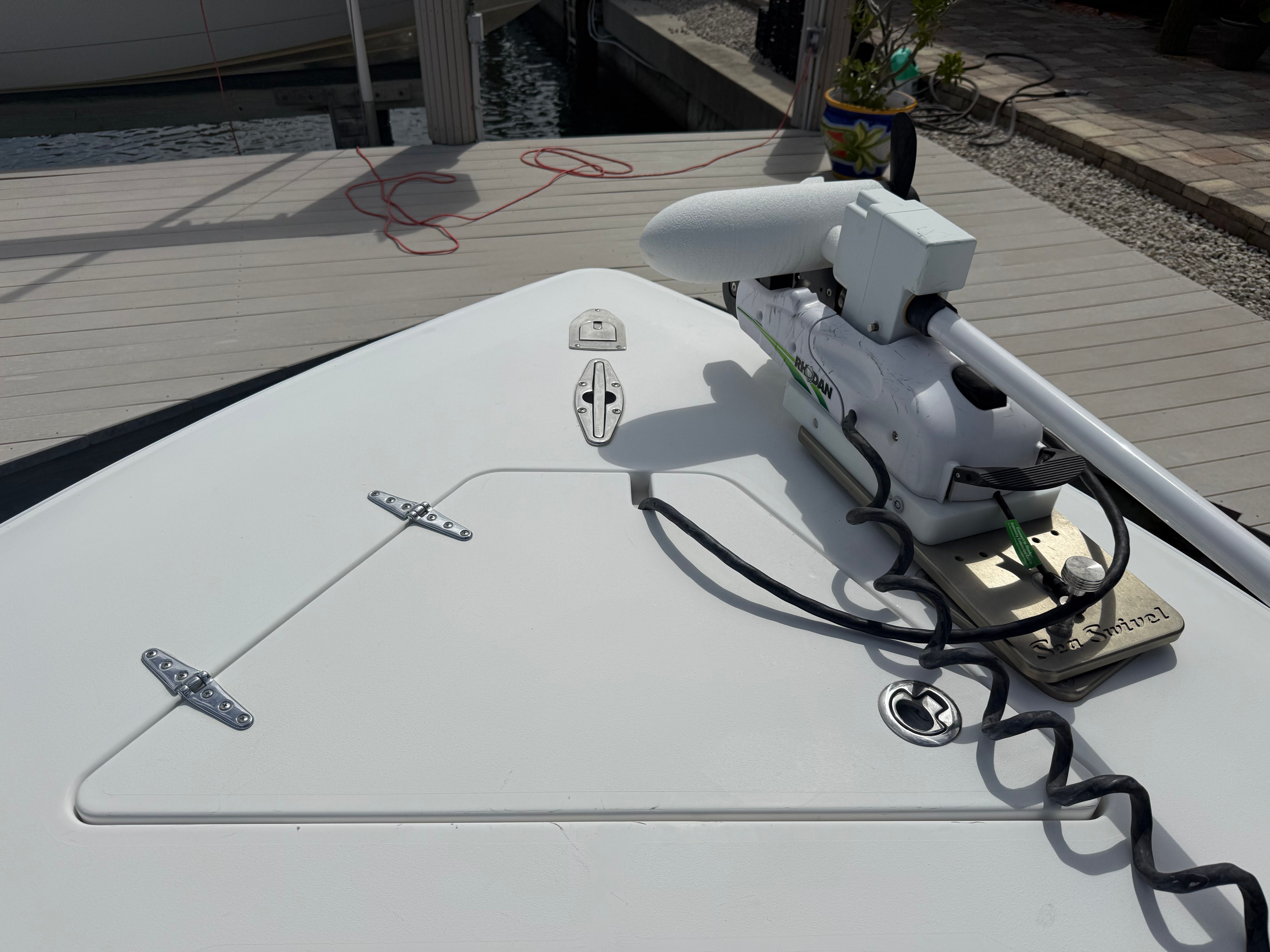 2012 Contender 32 ST boat with mounted trolling motor at dock.