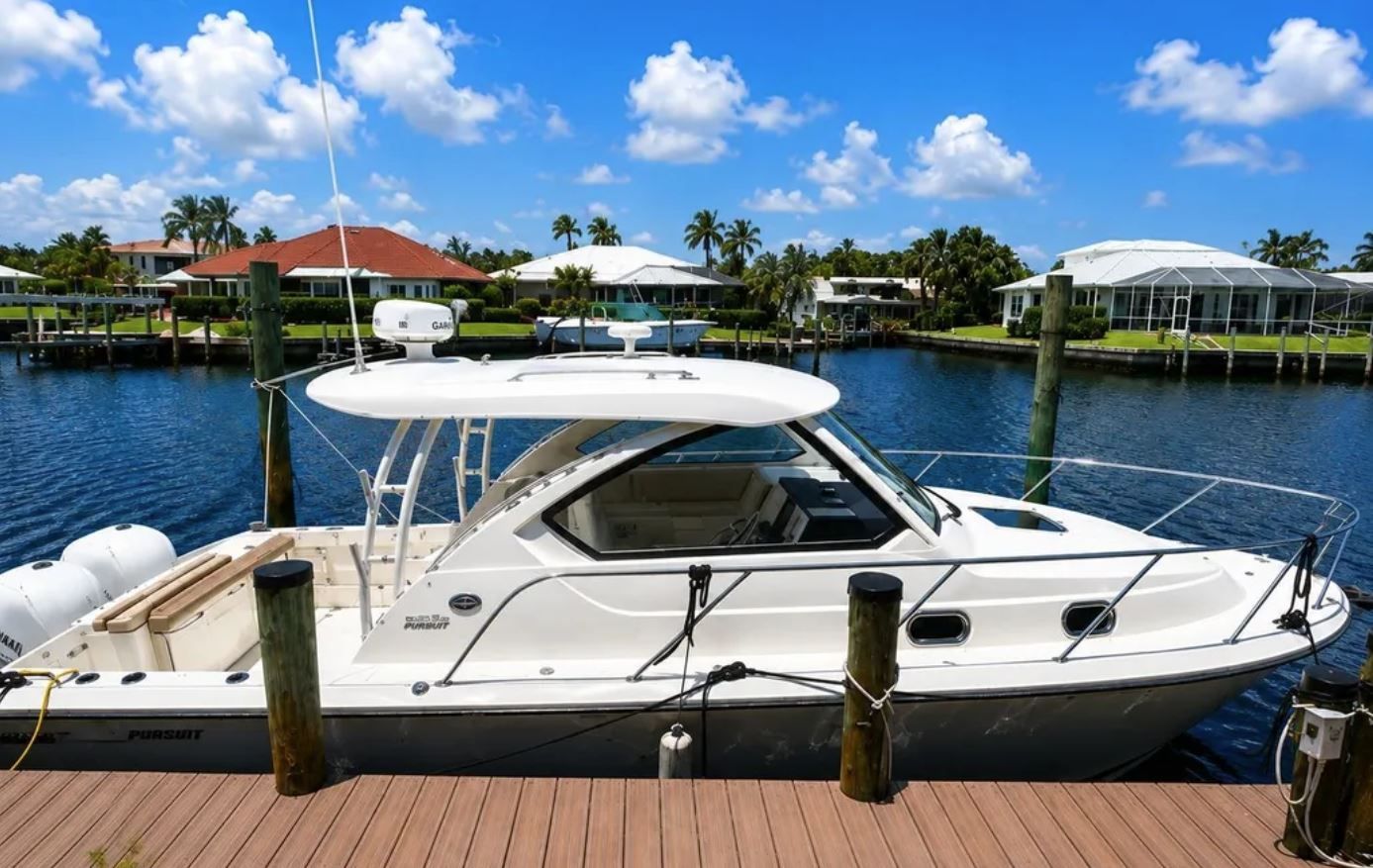 2016 Pursuit OS 325 Offshore boat docked on a sunny day.