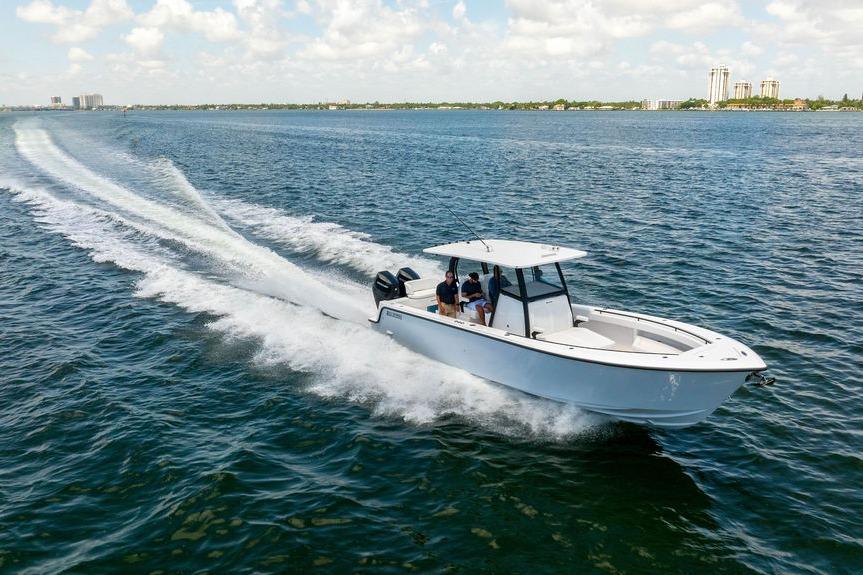 2027 Reef Runner 340 boat cruising on open water under a clear sky.