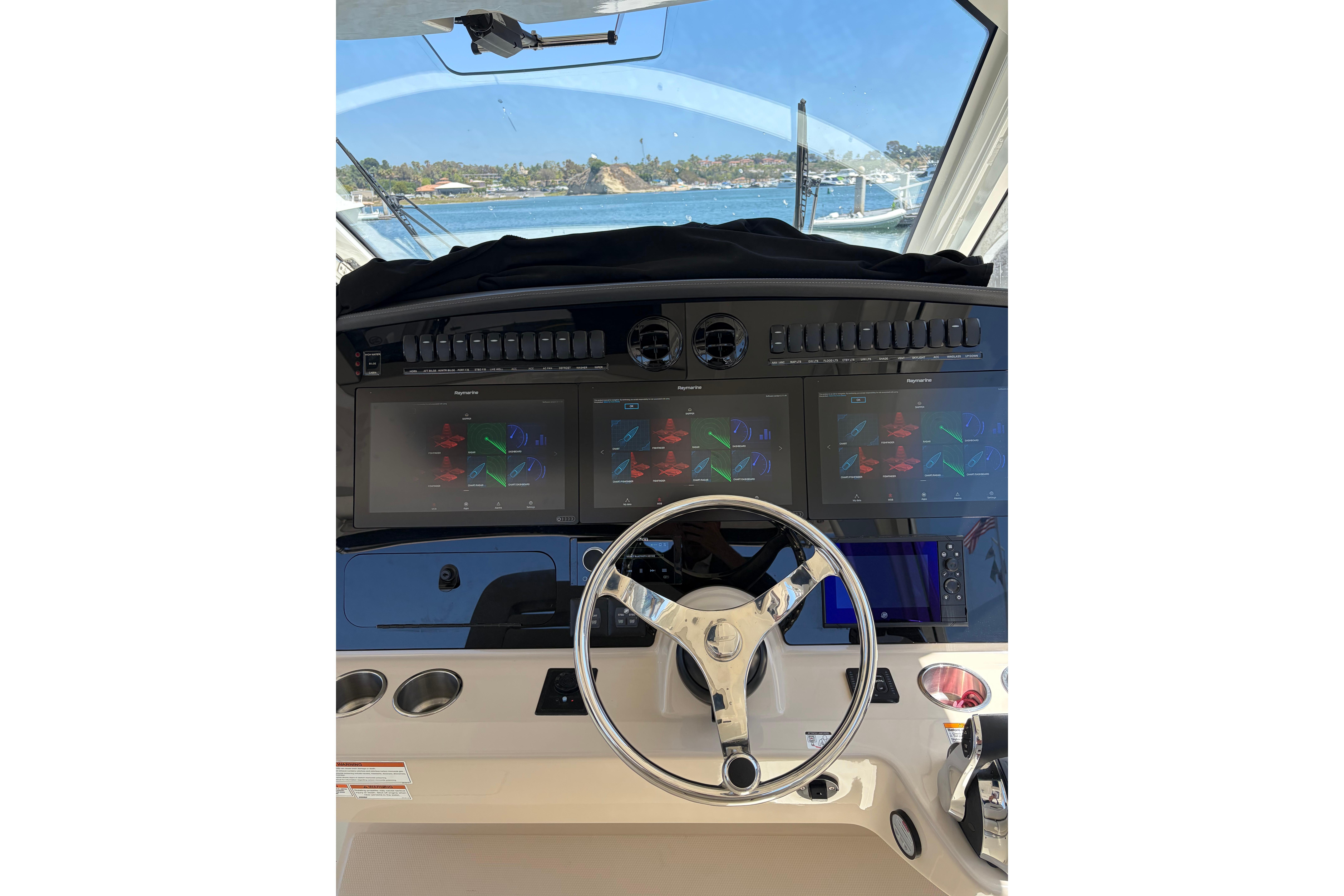 2020 Boston Whaler 380 Realm helm with advanced navigation displays and steering wheel.