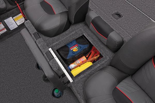 An open storage compartment on a boat with various items inside.