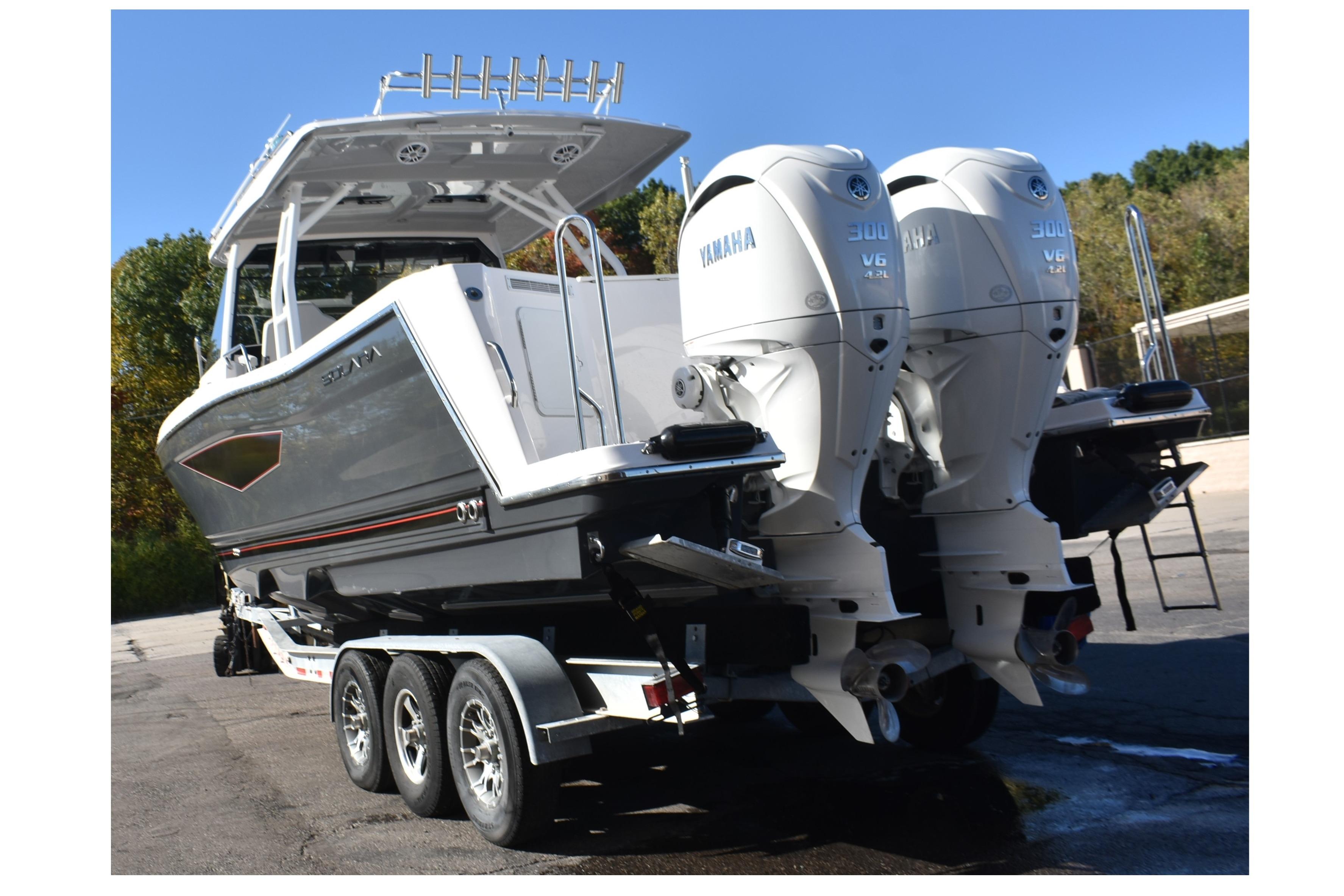 2025 Solara S-310 CW boat with dual Yamaha 300 V6 engines on a trailer.