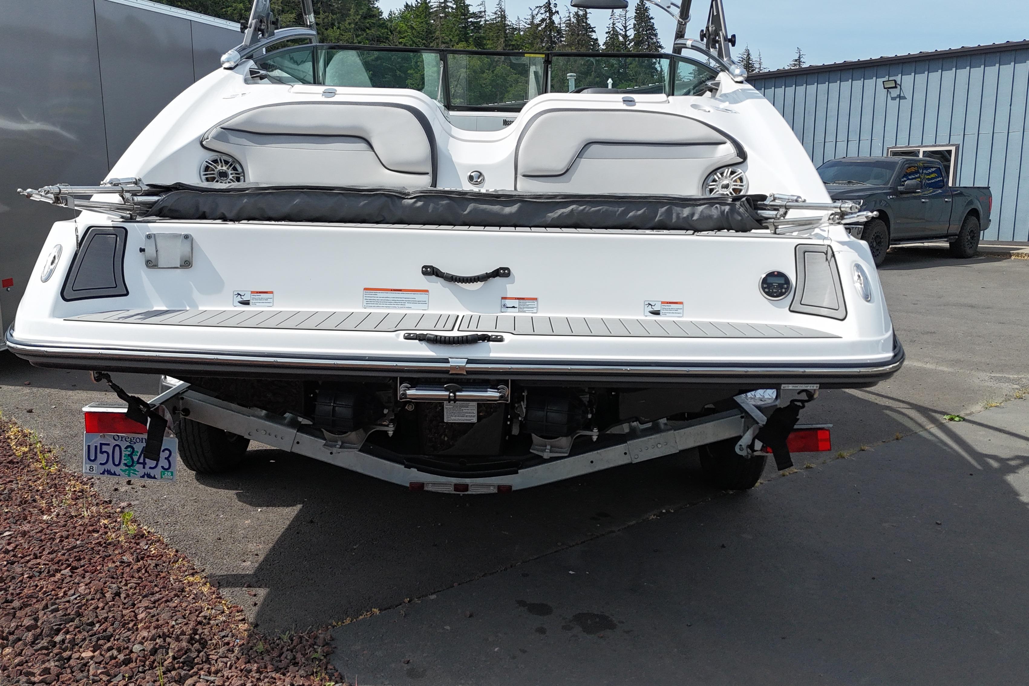Rear view of a 2016 Yamaha Boats 212X on a trailer, parked outdoors.
