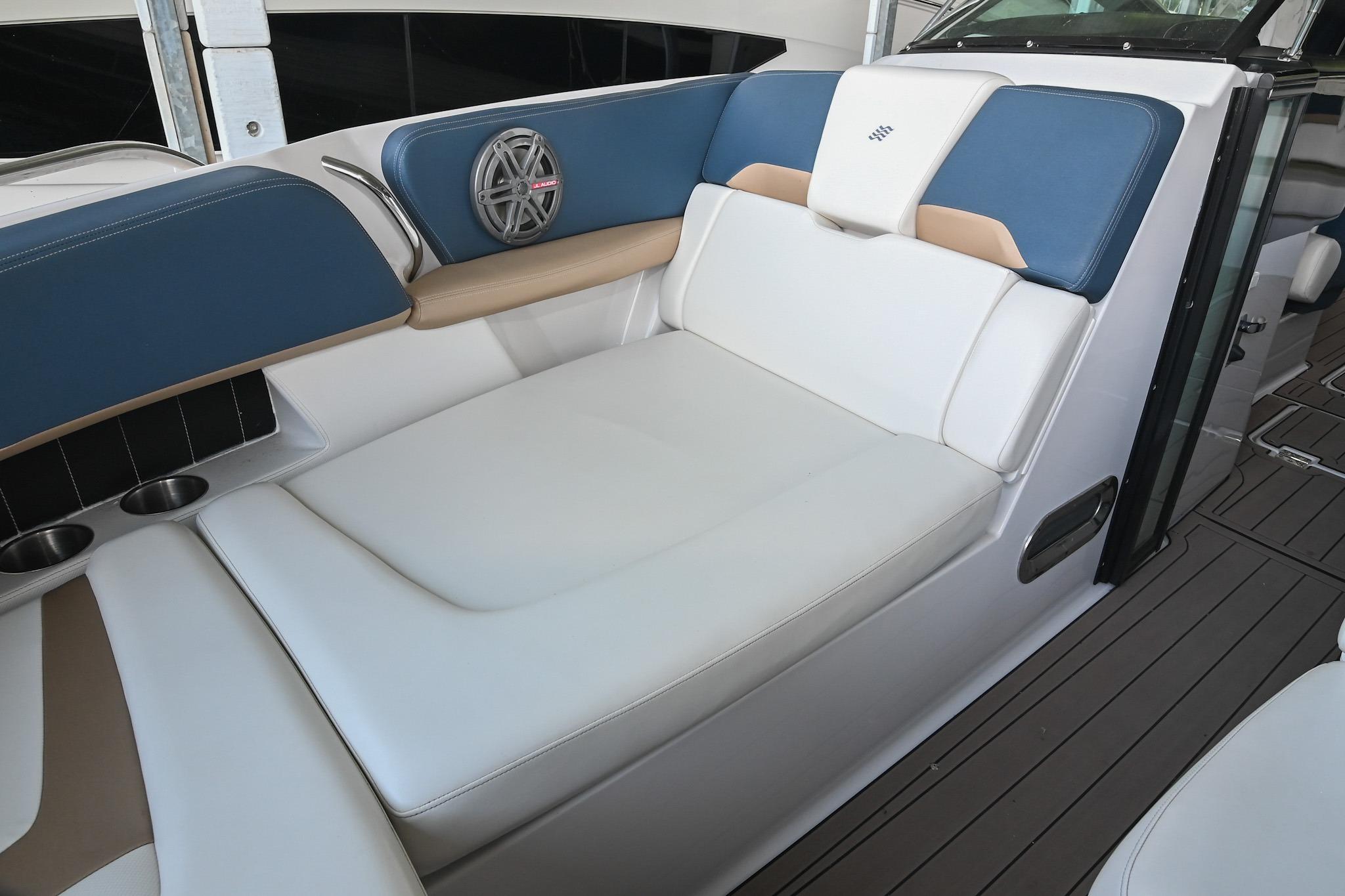 Luxurious seating area on a 2014 Four Winns H290 boat, featuring blue and white upholstery.