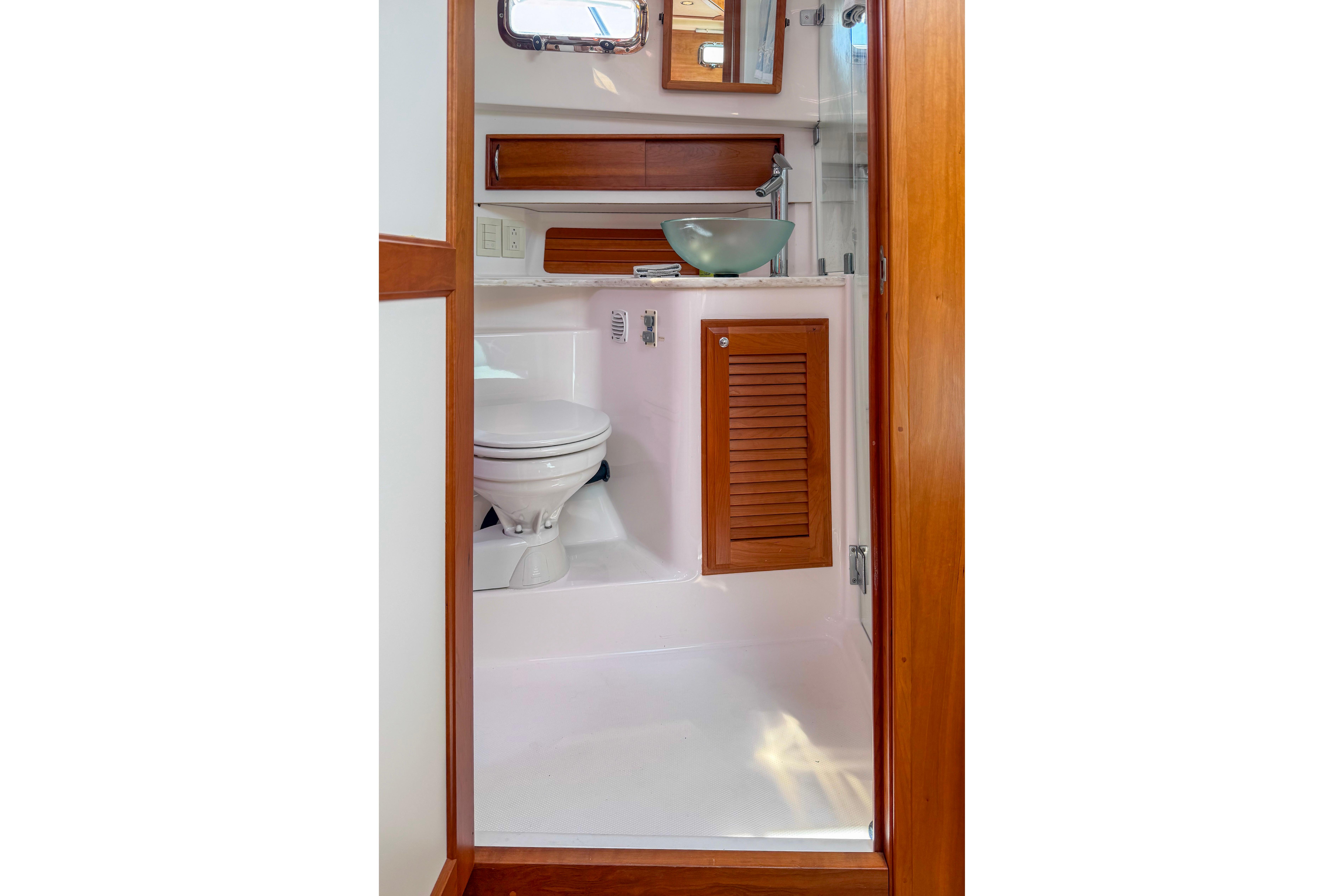 2013 Sabre 38 Salon Express bathroom with wooden accents and modern fixtures.