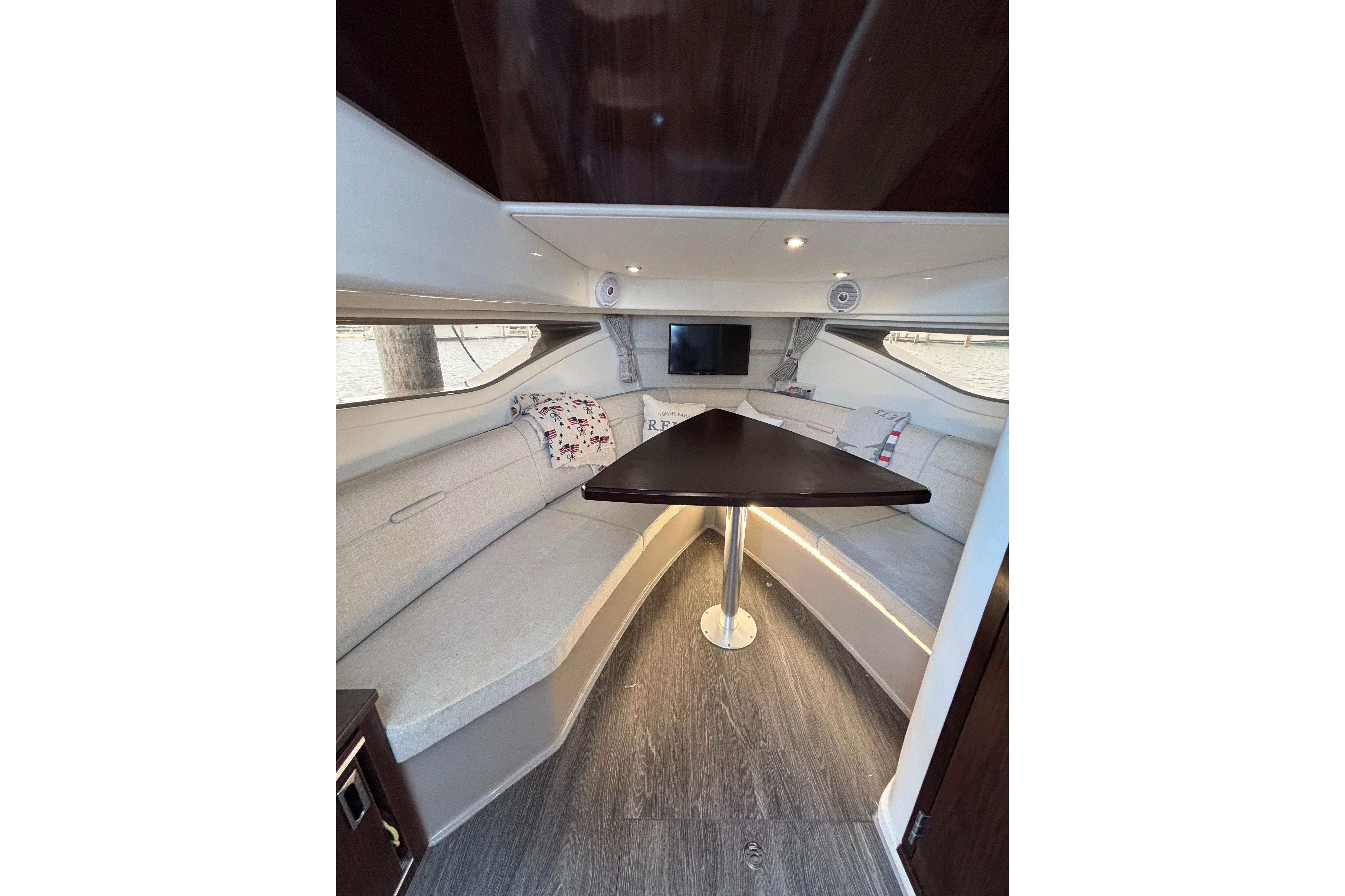 2021 Sea Ray Sundancer 320 Outboard cabin interior with elegant seating and table.