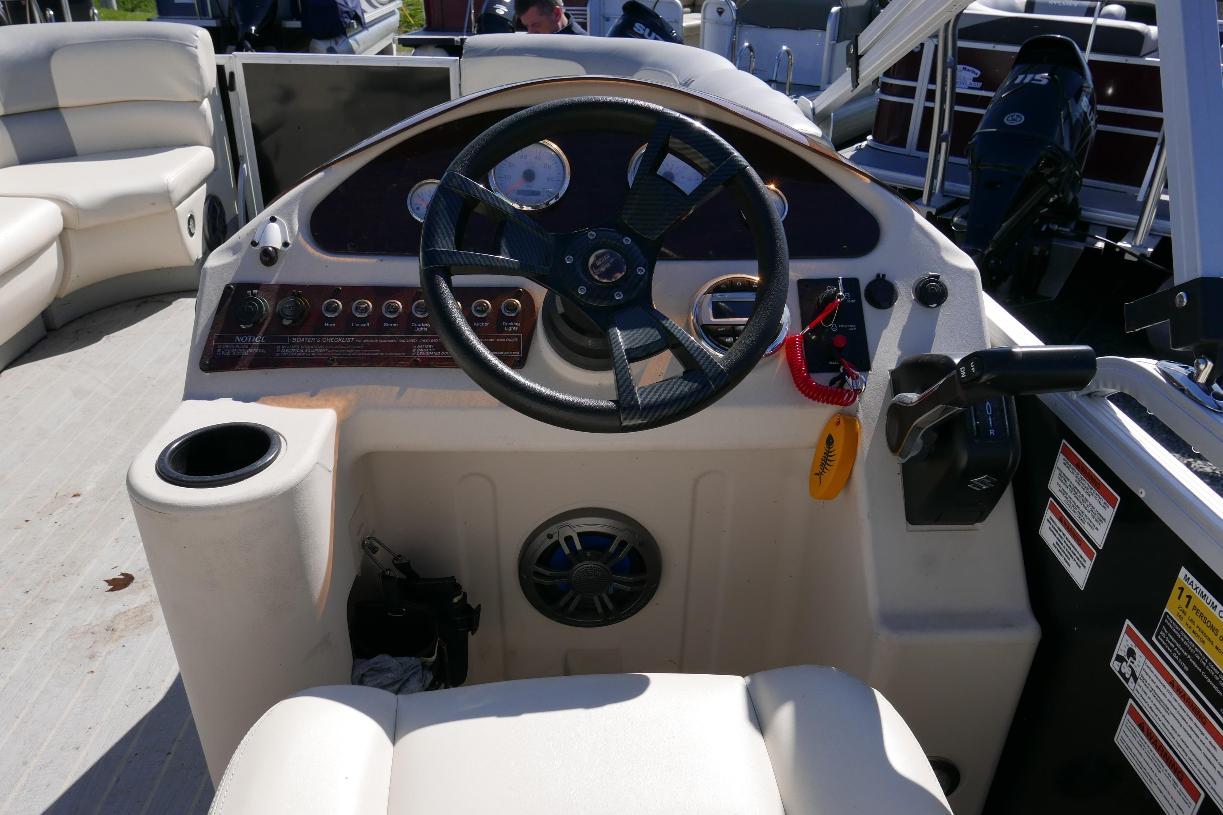 2022 Lexington 320HPT boat dashboard with steering wheel and control panel.