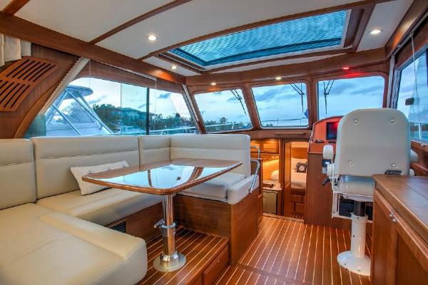 Interior of a 2027 Sabre 38 Salon Express with elegant wood accents and panoramic windows.