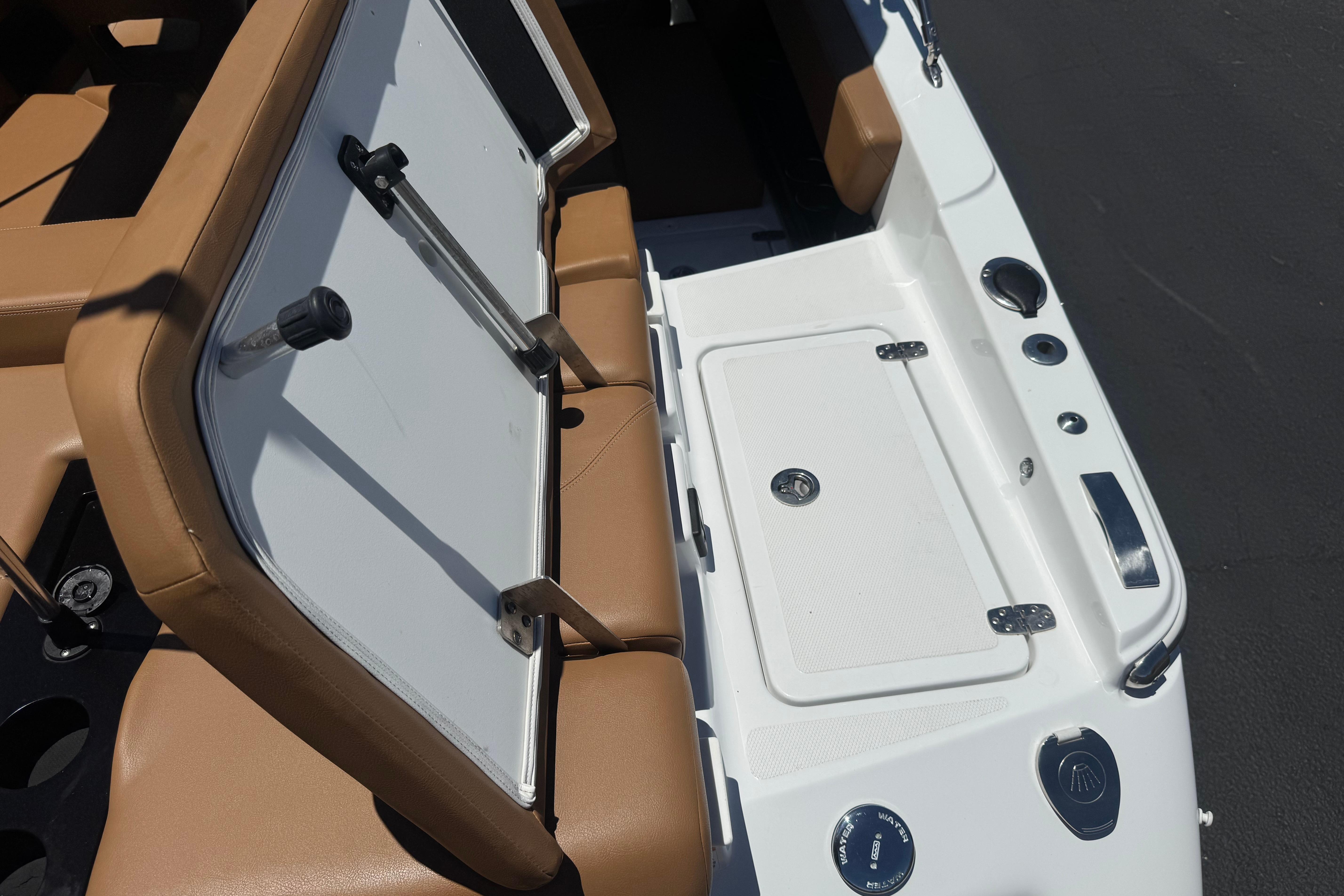 2022 Four Winns H4 boat interior with tan seating and storage compartment.